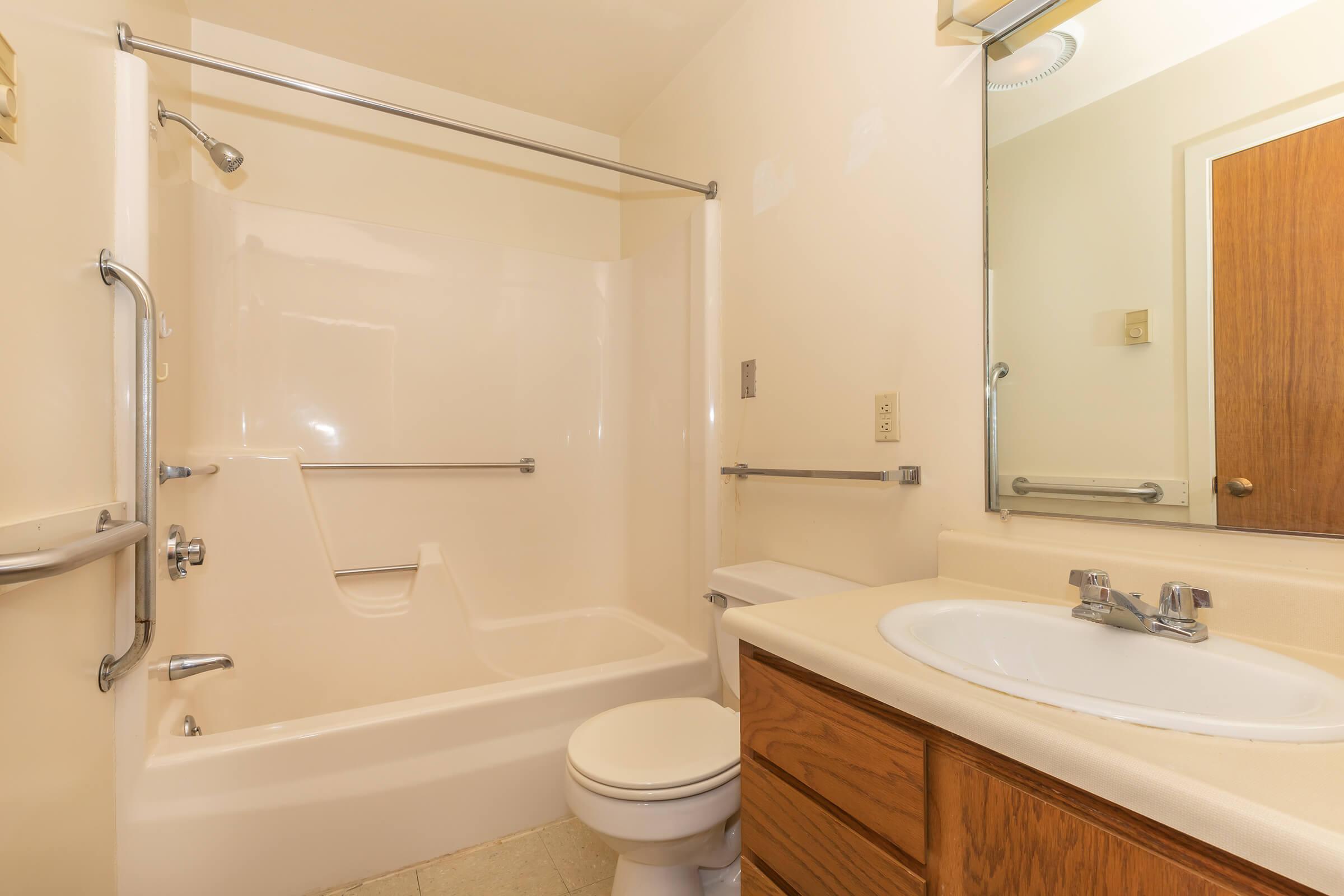 a large white tub sitting next to a sink