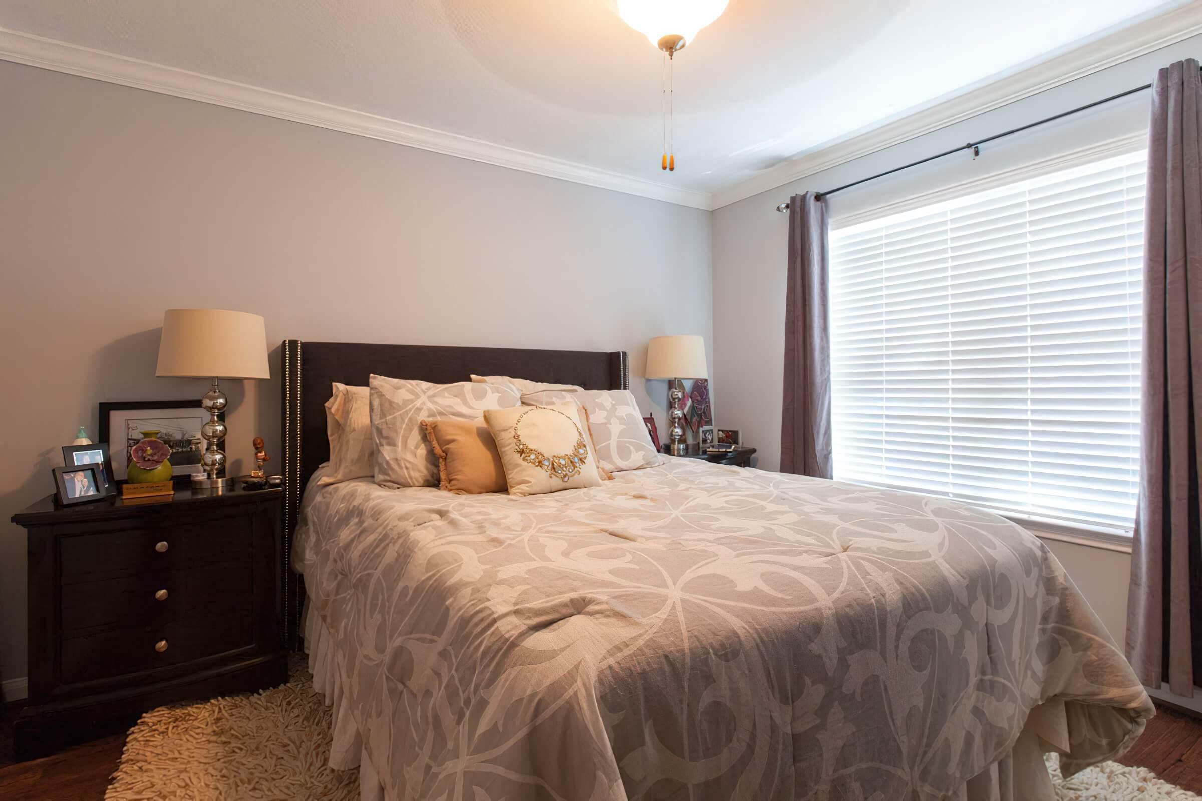 a bedroom with a bed and desk in a room