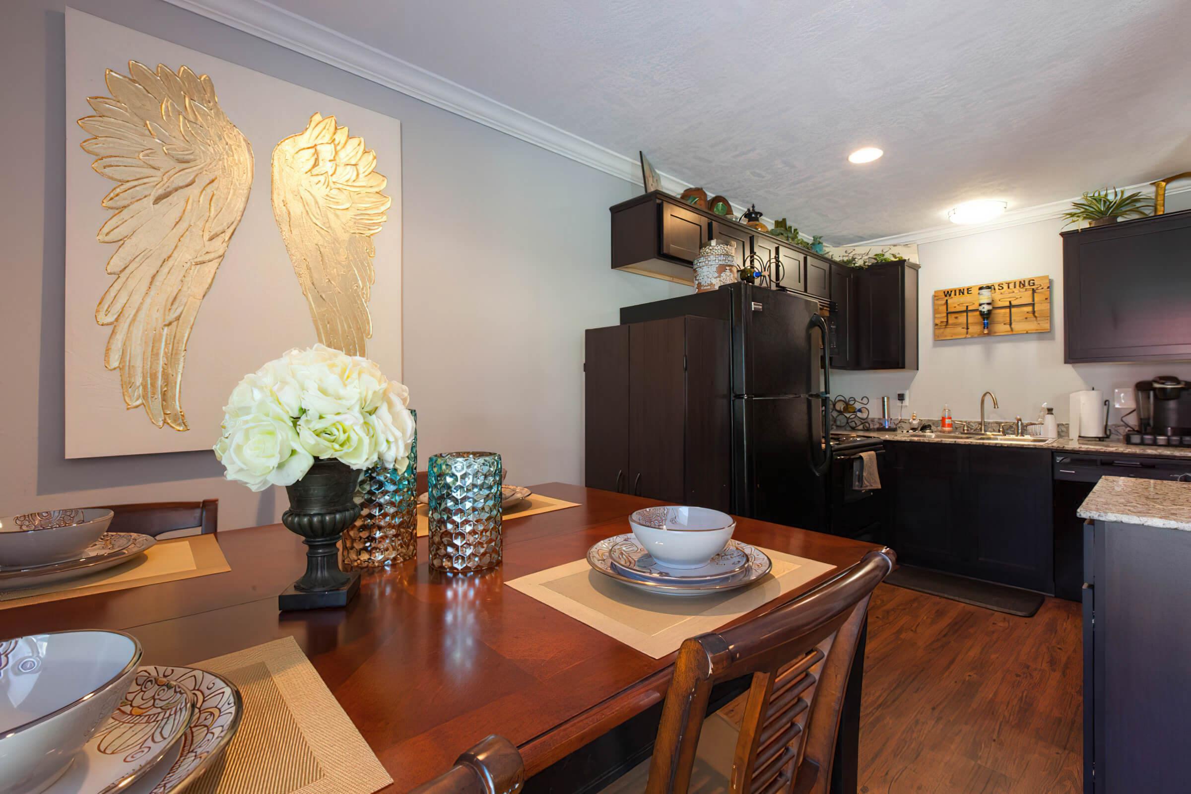 a living room filled with furniture and vase of flowers on a table