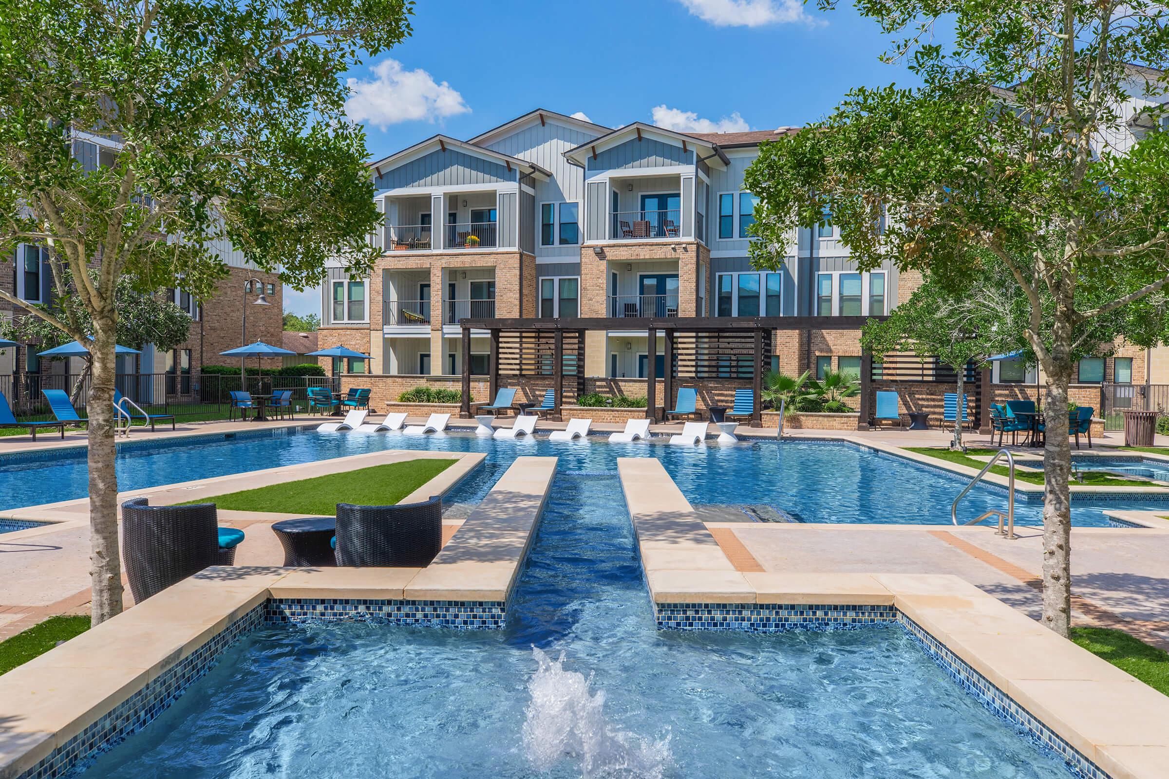 a building with a pool in a park