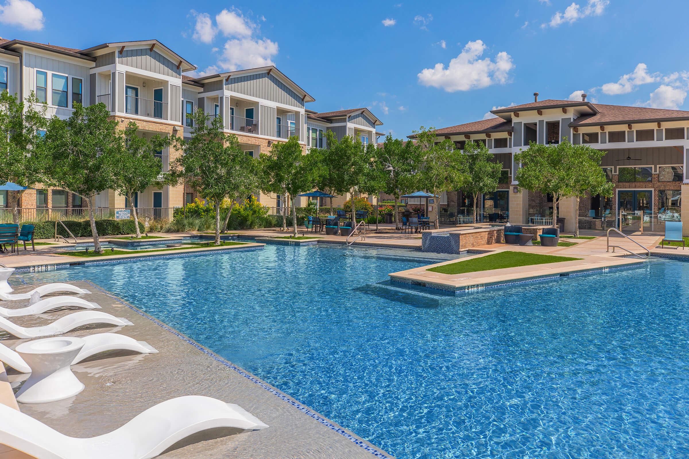 a large pool of water in front of a house