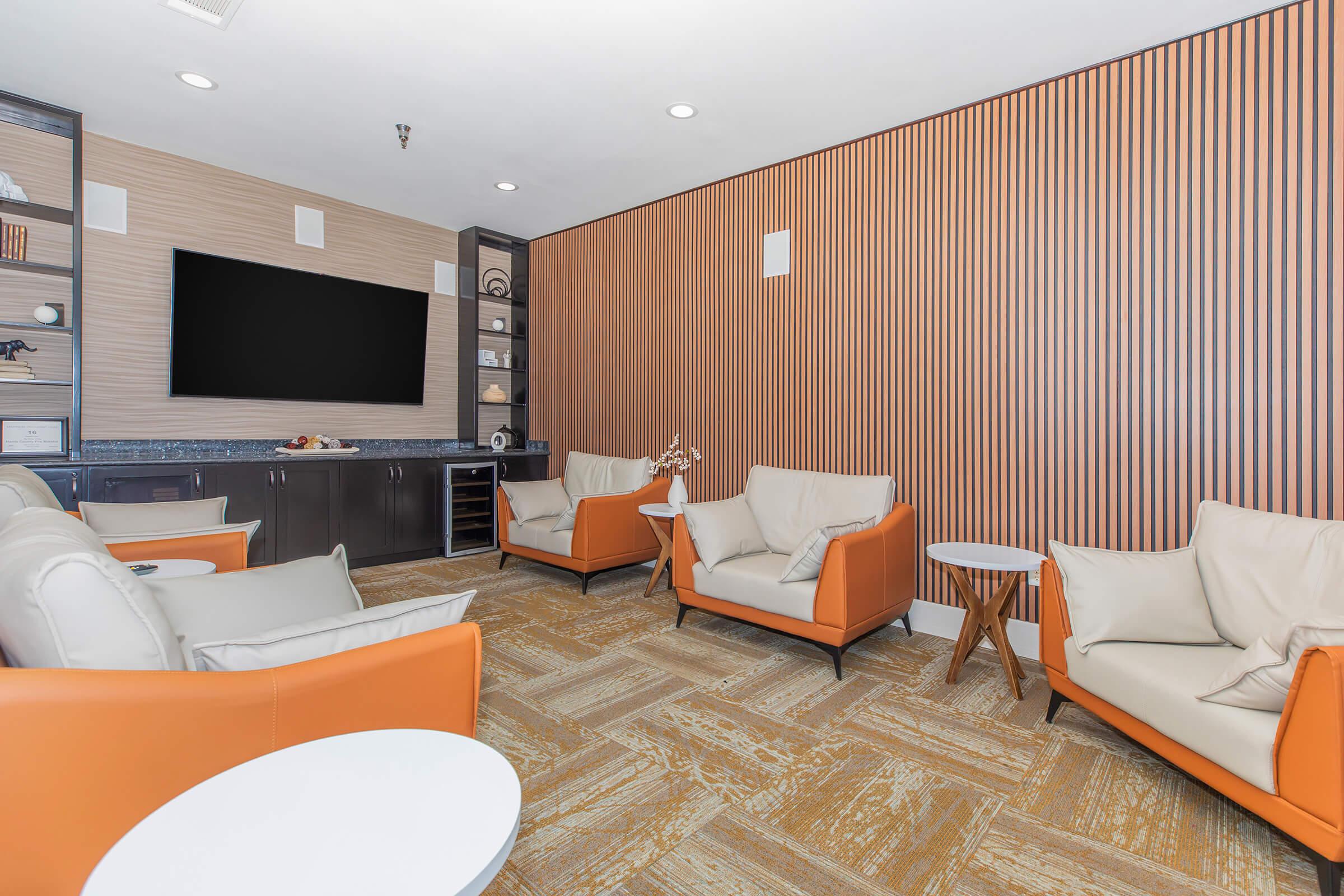 a living room filled with furniture and a flat screen tv