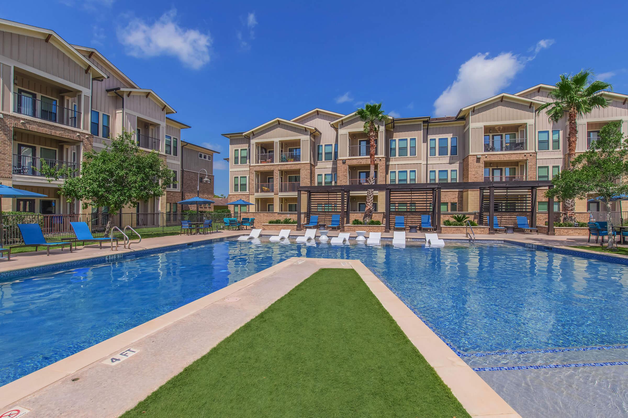 a large pool of water in front of a house