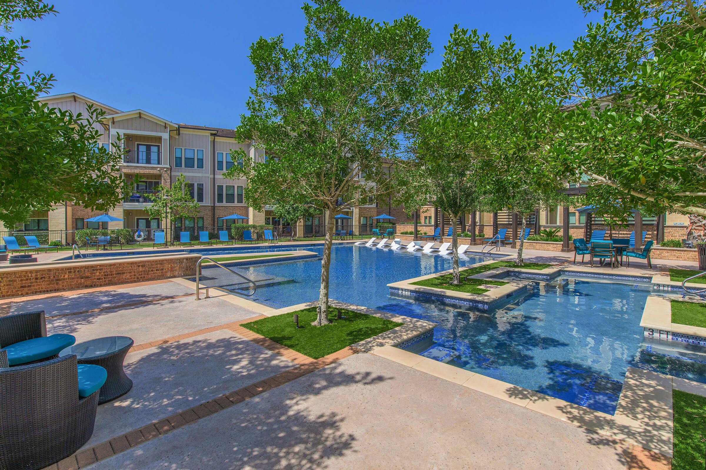 a tree in front of a pool