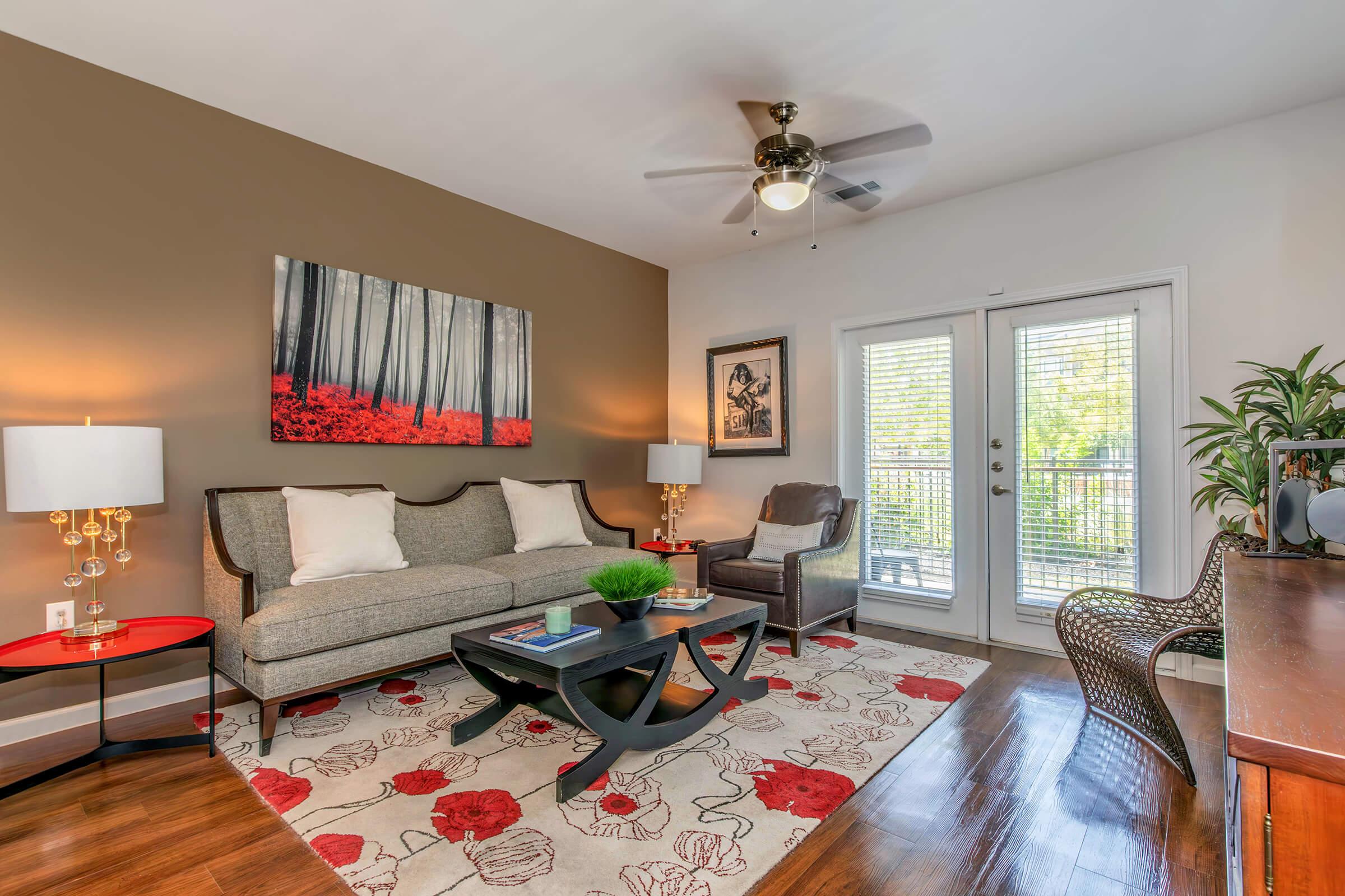 a living room filled with furniture and a flat screen tv