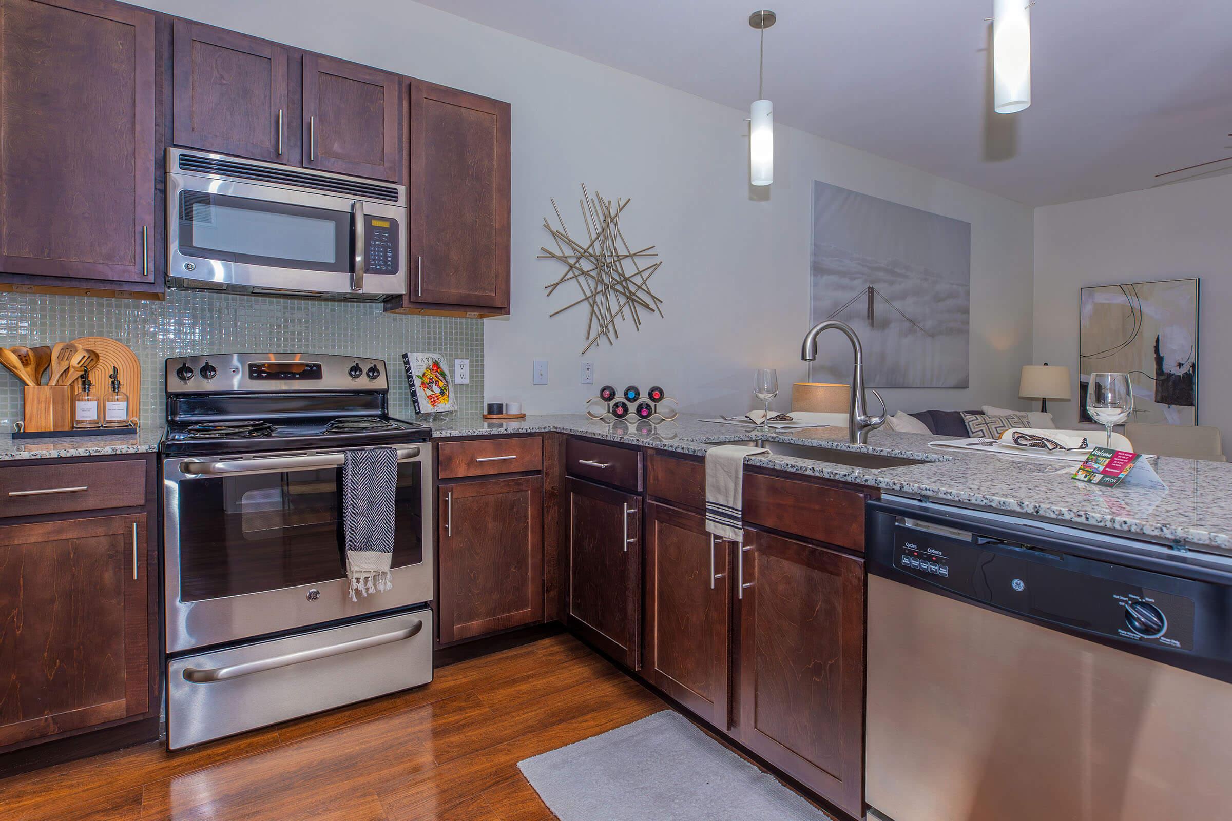 a kitchen with stainless steel appliances and wooden cabinets