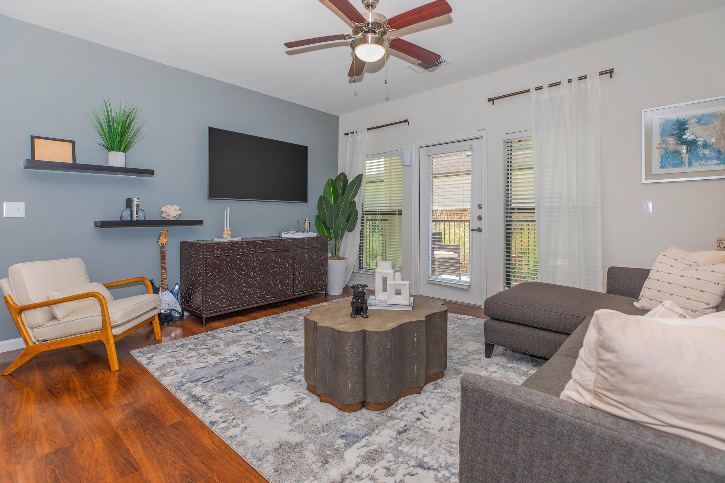 a living room filled with furniture and a large window