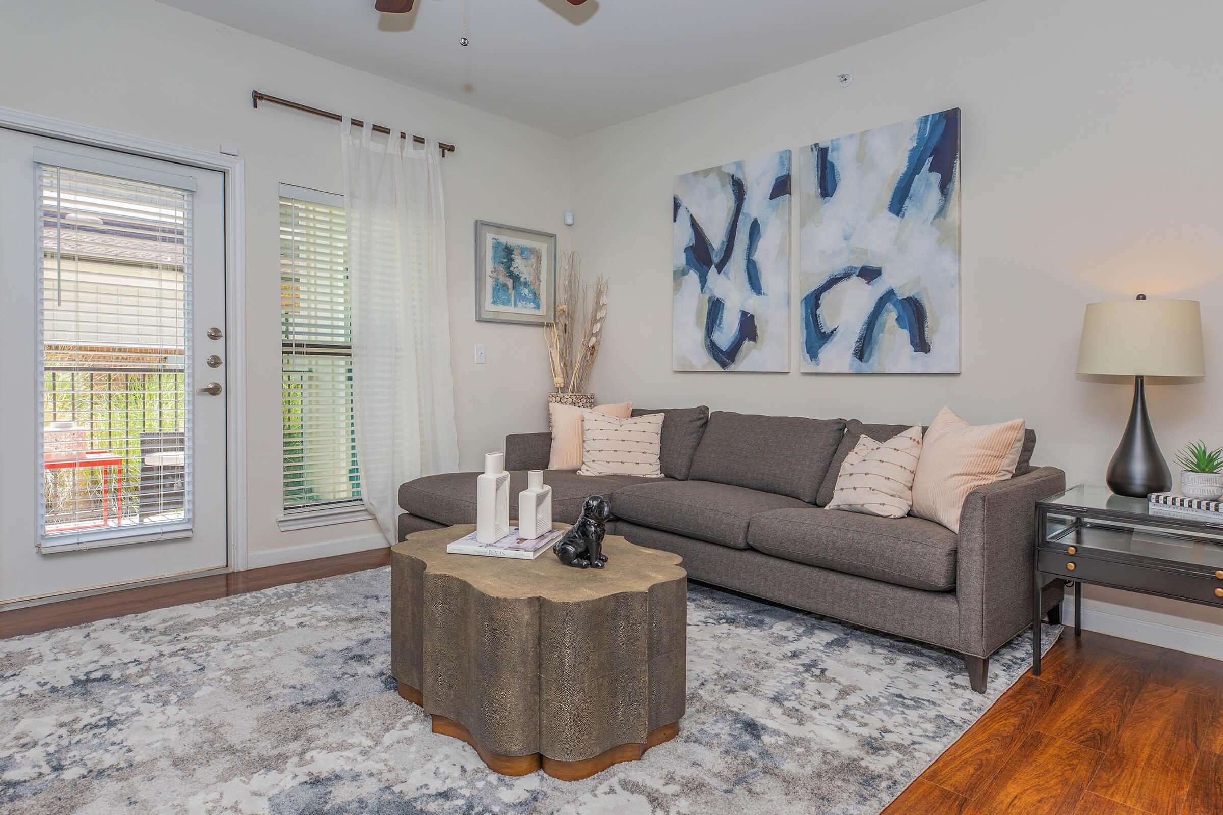 a living room filled with furniture and a large window