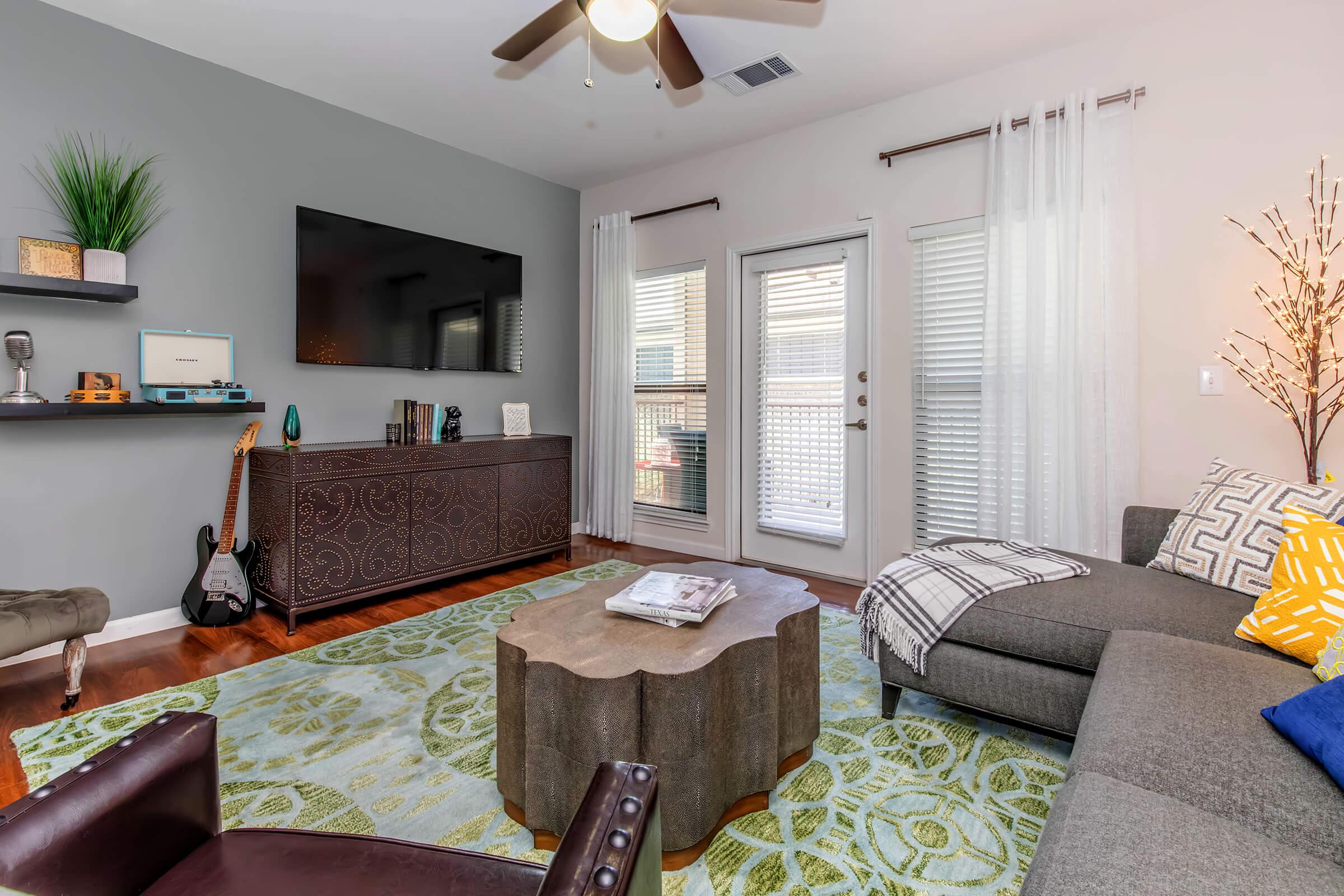 a living room filled with furniture and a large window