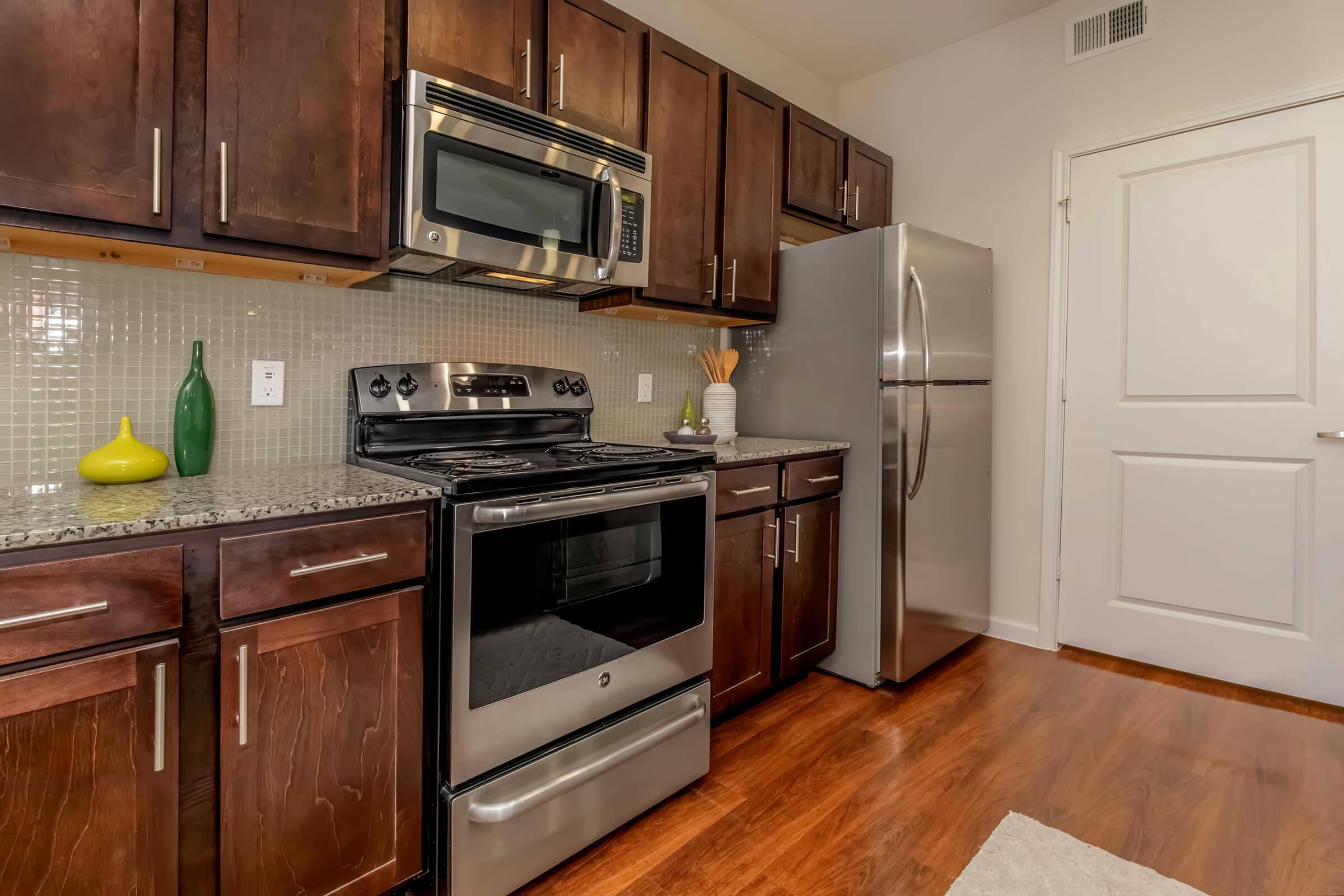 a kitchen with stainless steel appliances and wooden cabinets