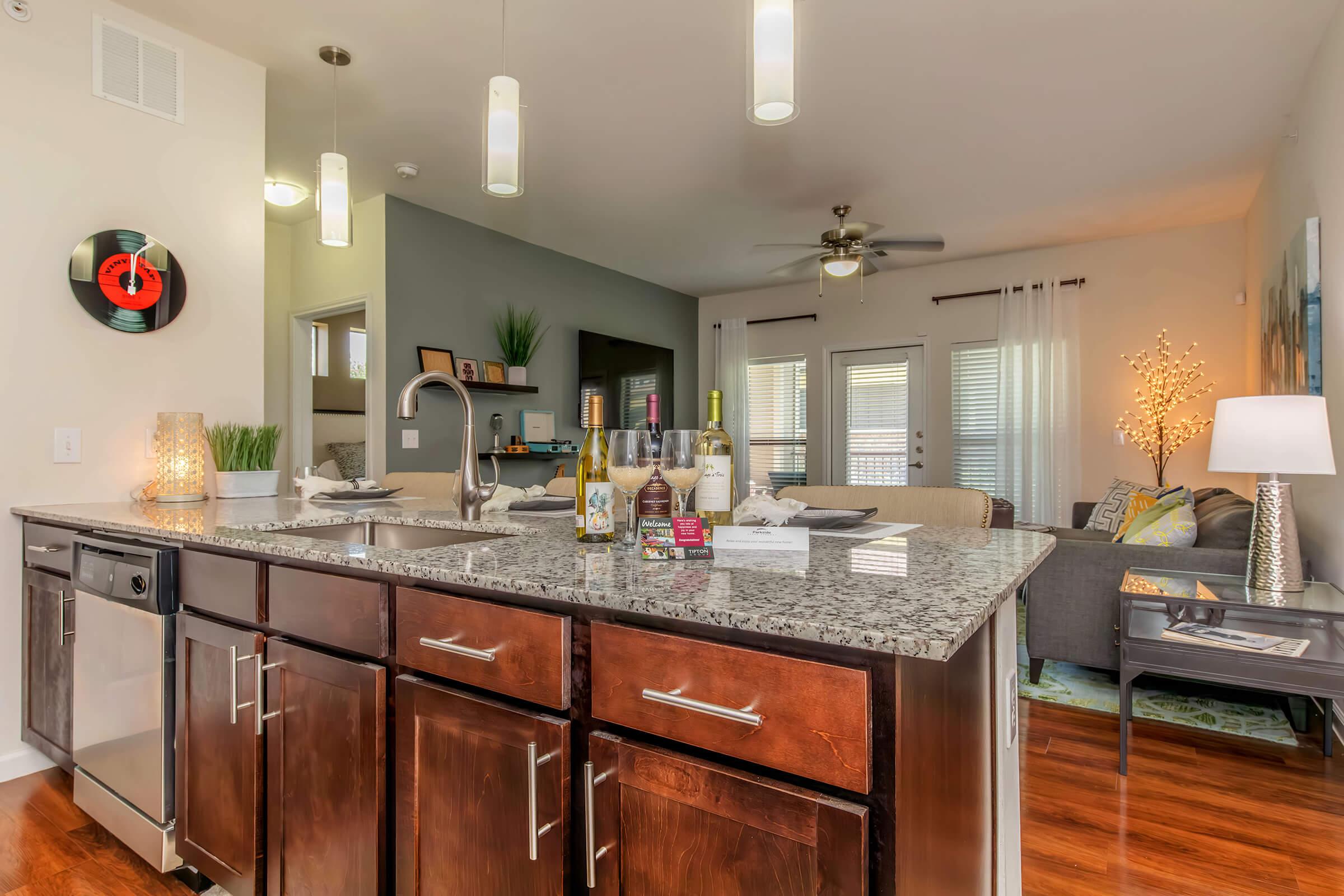 a modern kitchen with stainless steel appliances and wooden cabinets