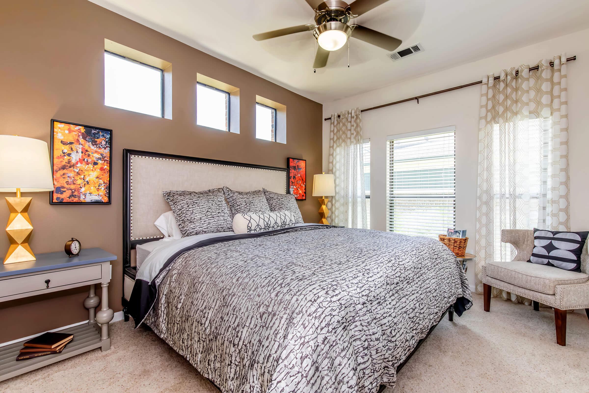 a bedroom with a bed and desk in a room