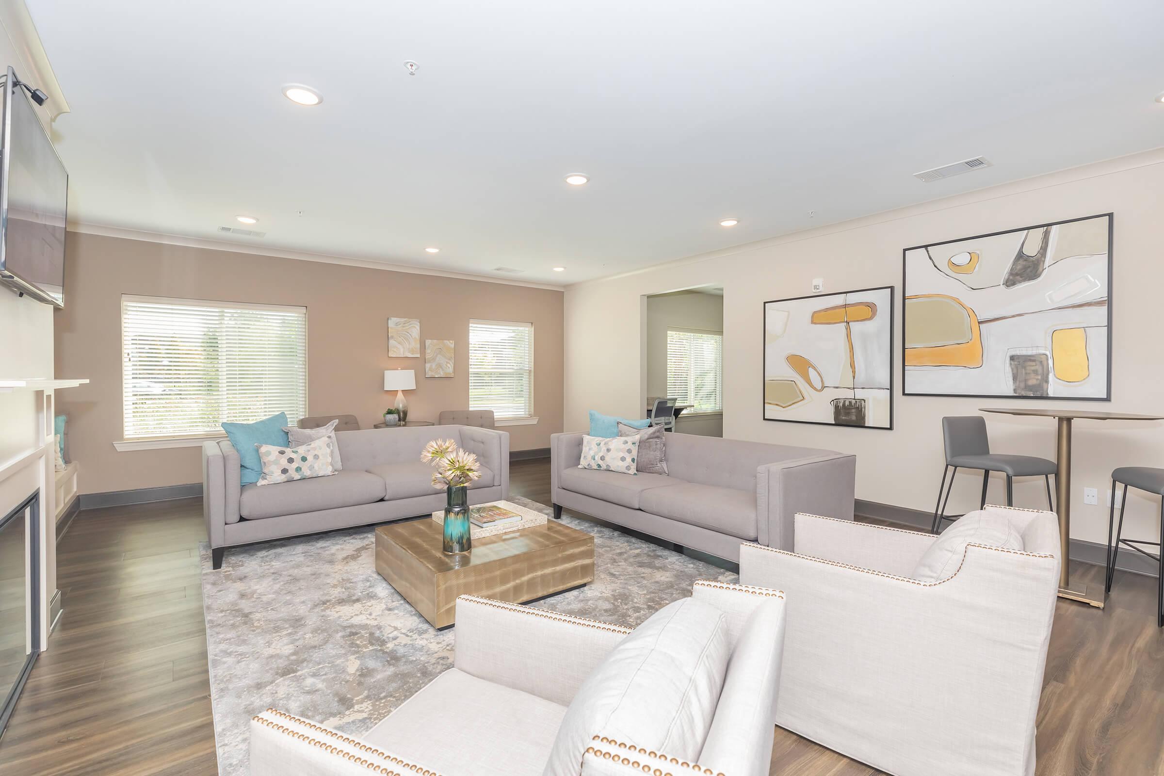 a living room filled with furniture and a large window