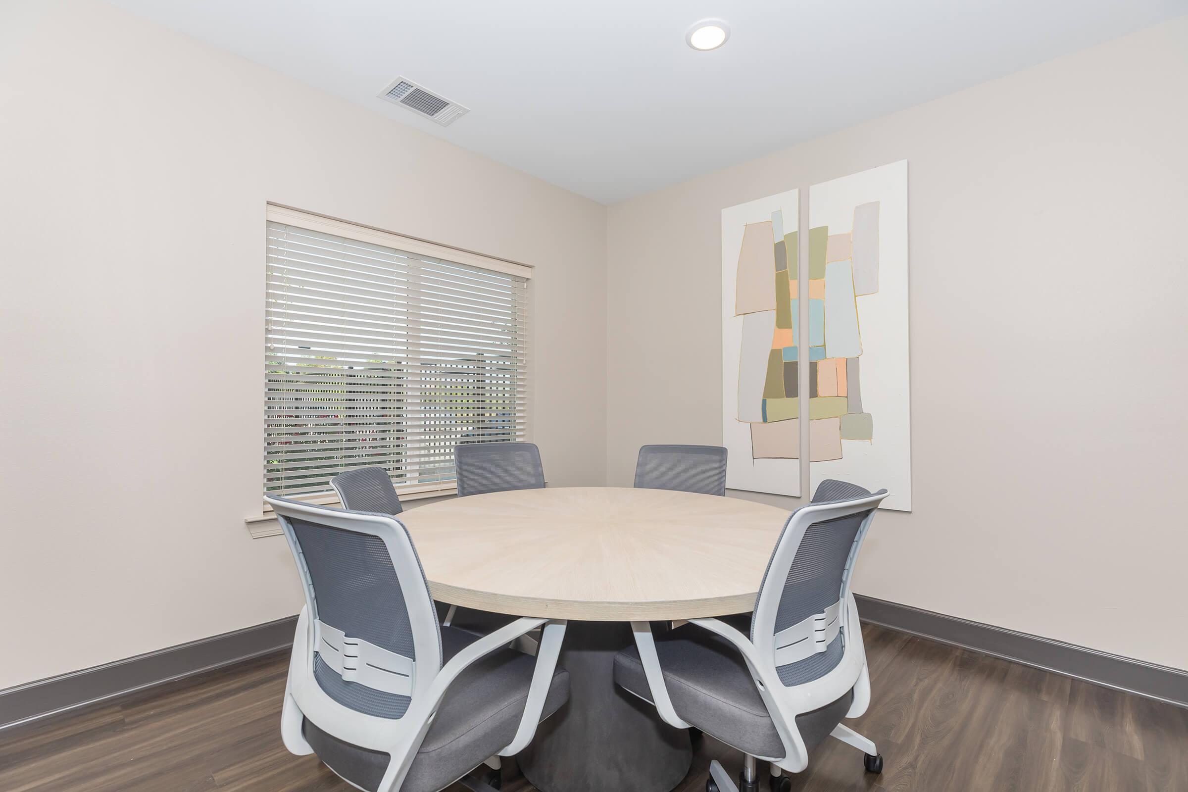 a bedroom with a desk and chair in a room