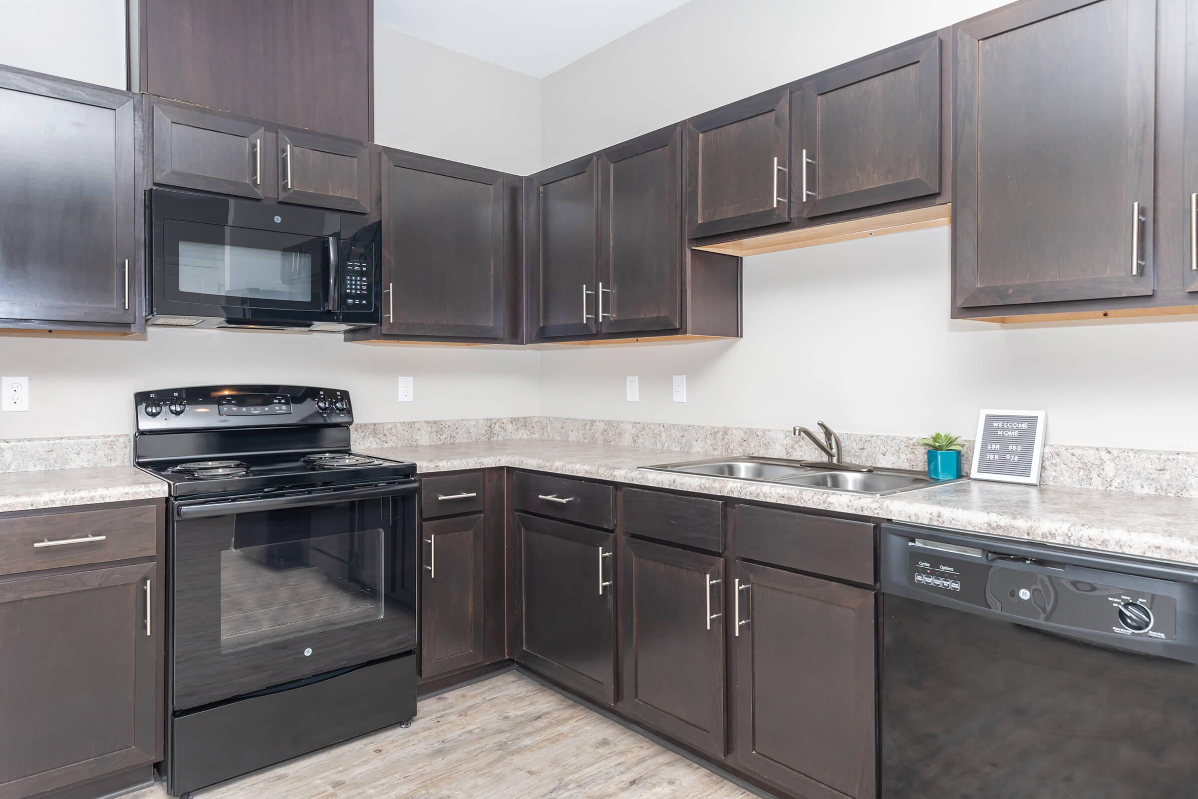 a kitchen with stainless steel appliances and wooden cabinets