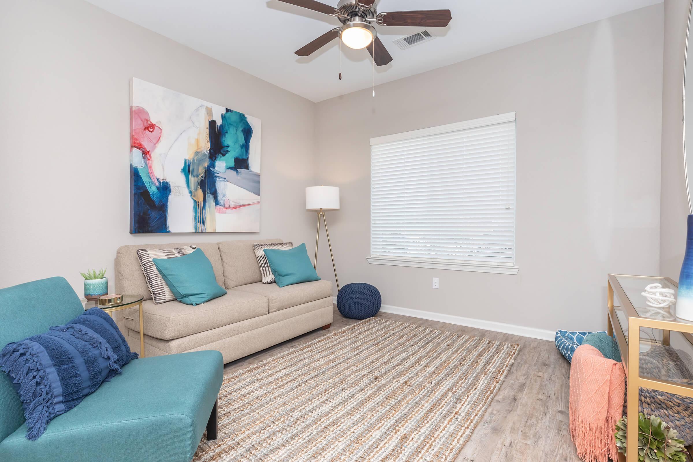 a bedroom with a bed and desk in a room