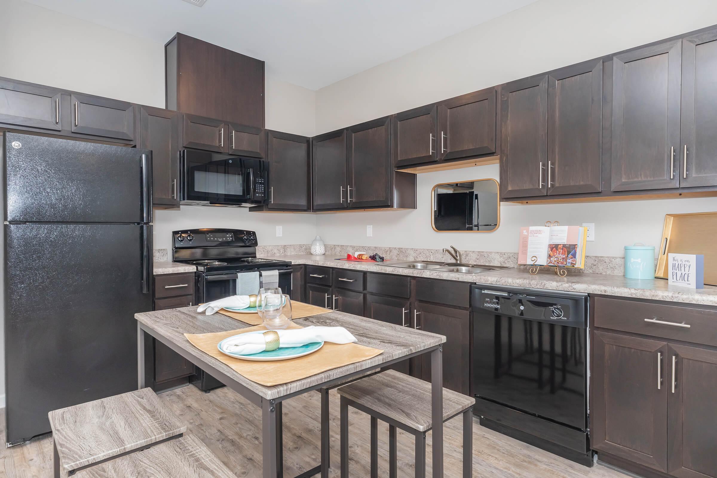 a modern kitchen with stainless steel appliances and wooden cabinets