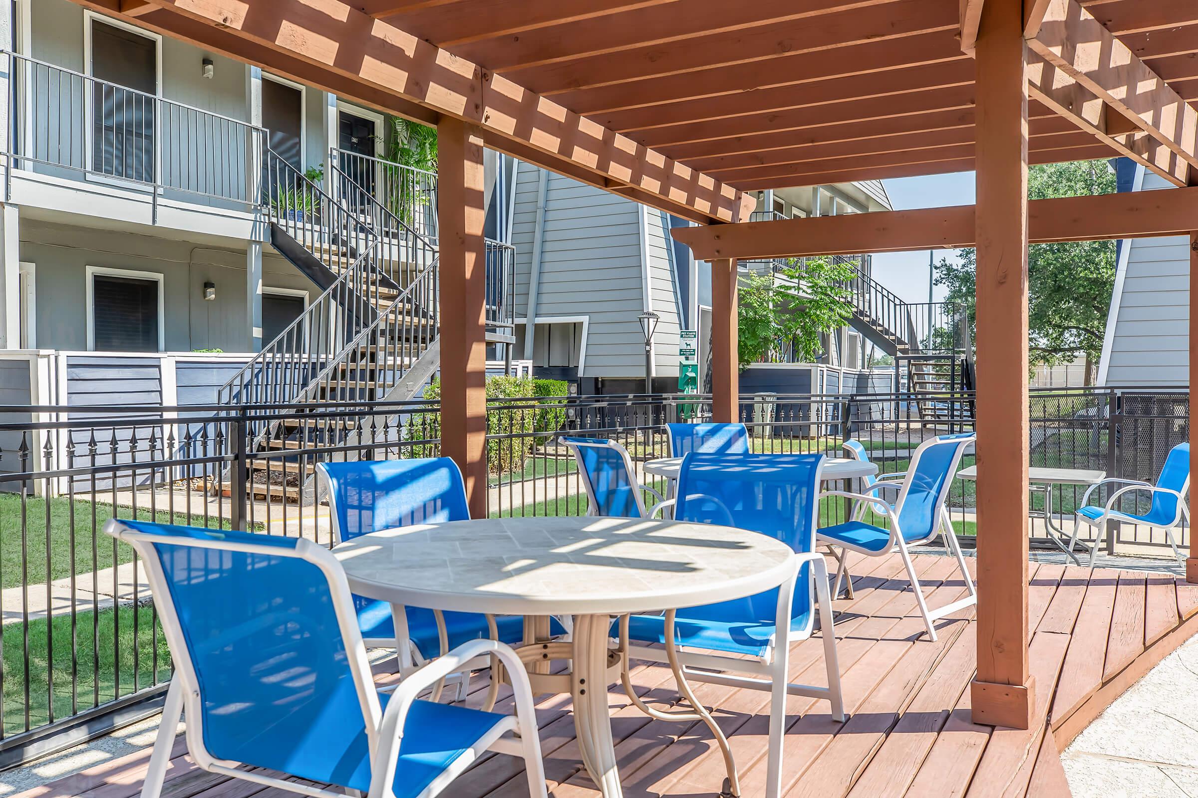 a couple of lawn chairs sitting on top of a wooden table