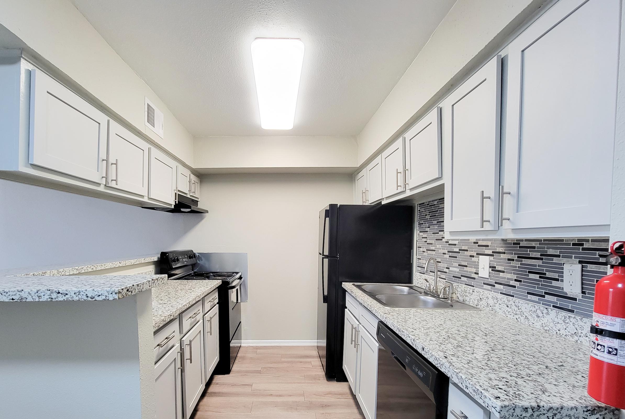 a kitchen with a sink and a window