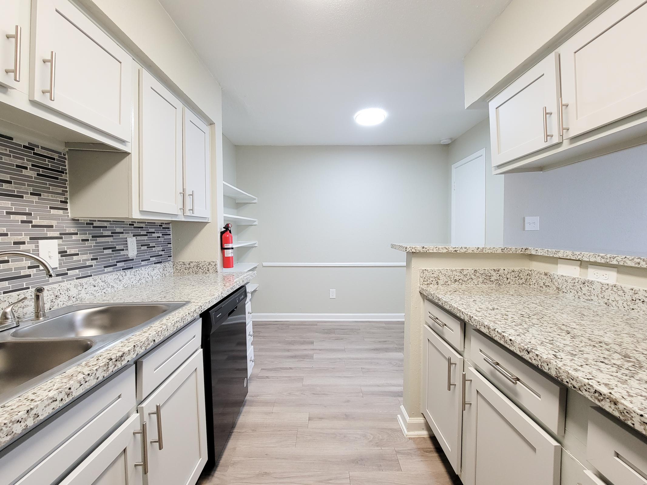 a kitchen with a stove and a sink