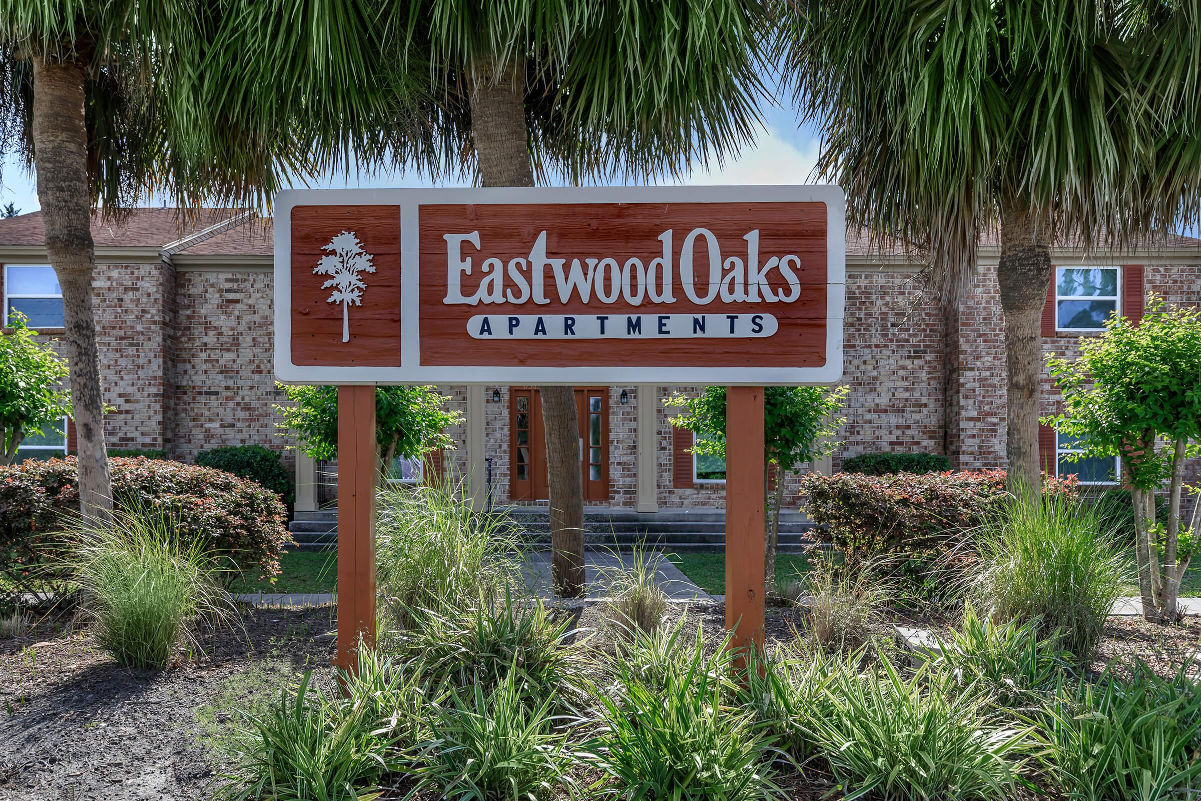 a sign in front of a tree