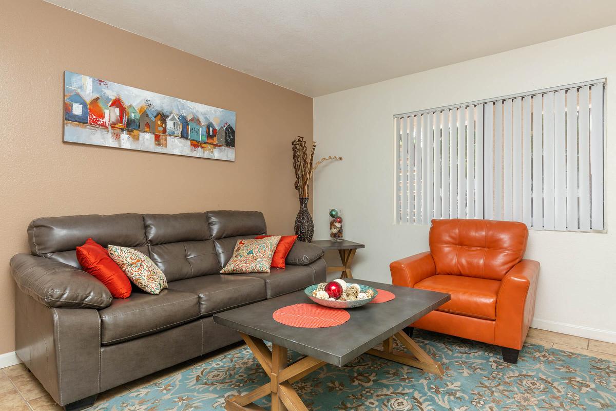 a living room filled with furniture and a flat screen tv
