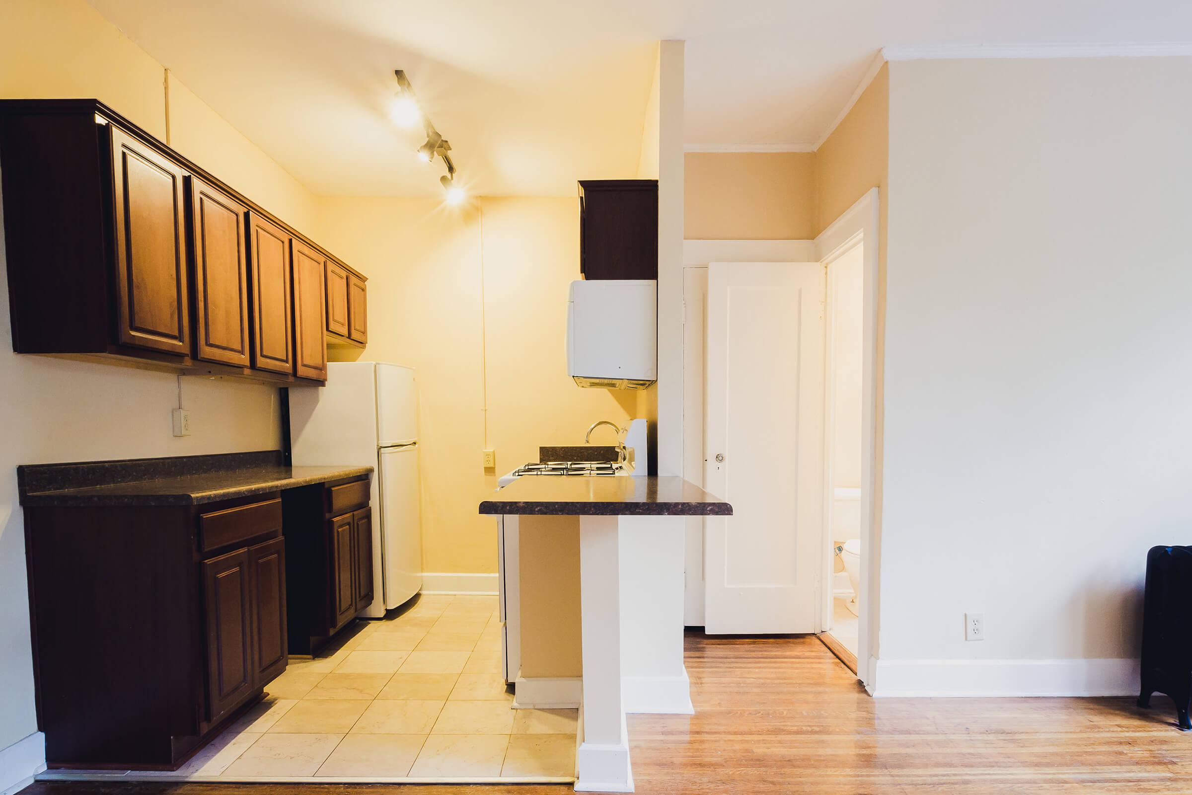 a kitchen with a refrigerator in a room