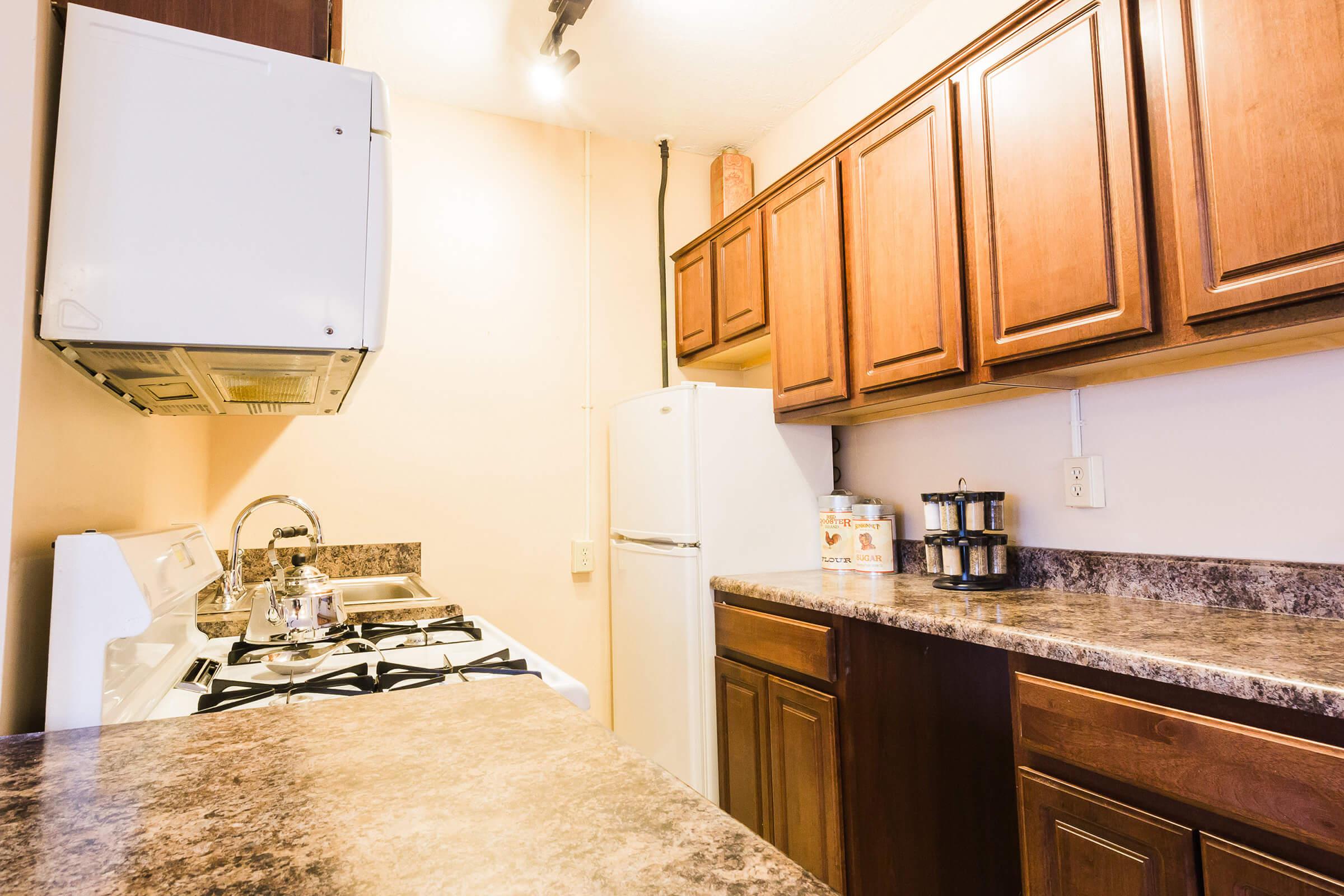 a kitchen with wooden cabinets