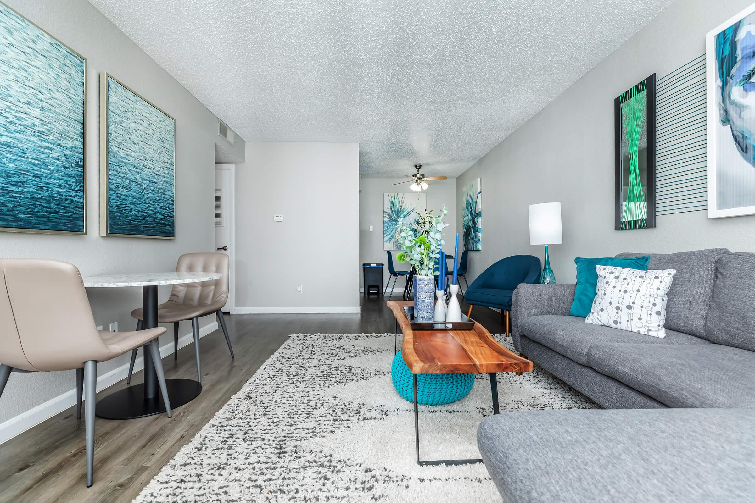 a living room filled with furniture and a lamp