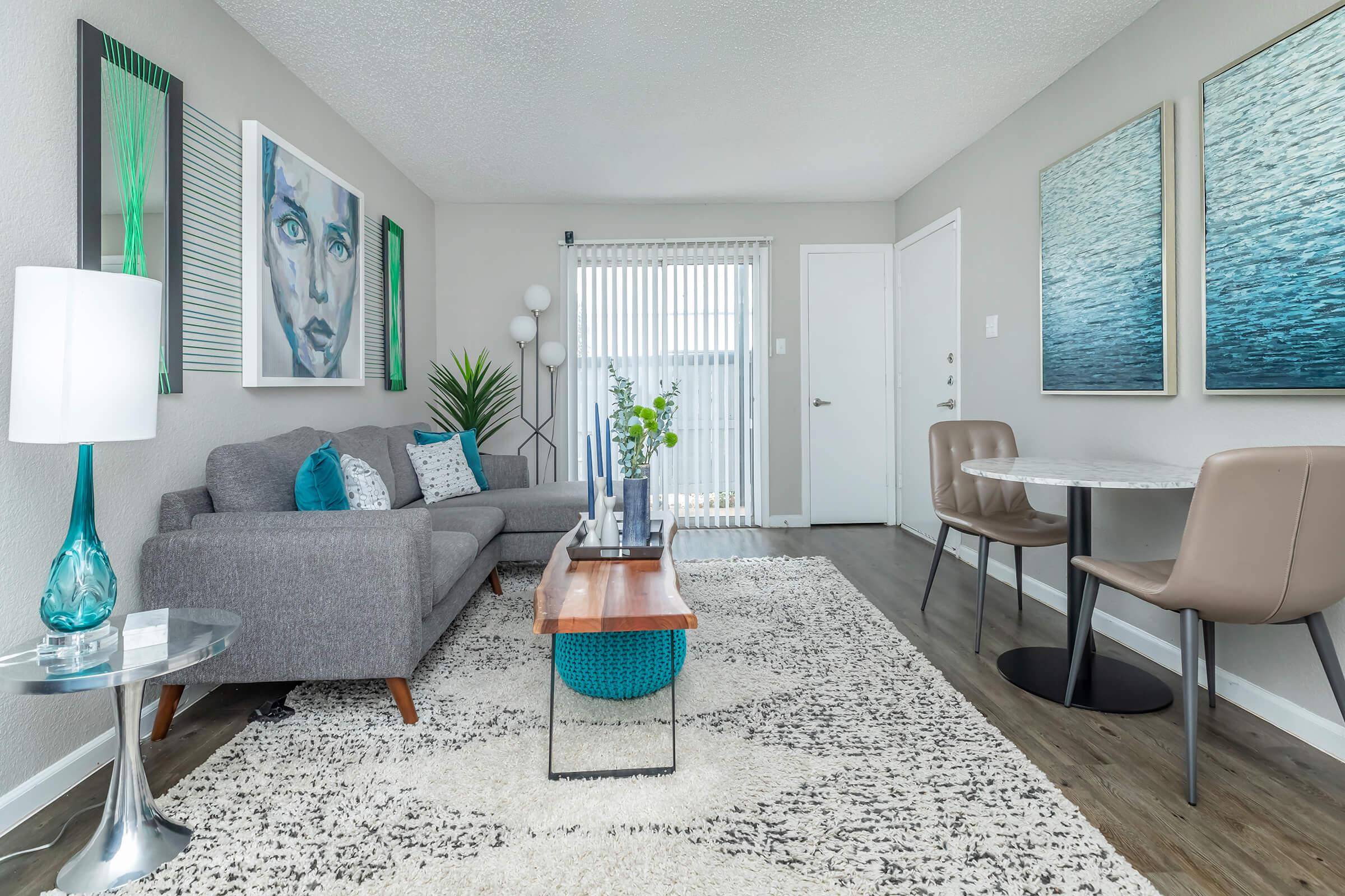 a living room filled with furniture and a large window