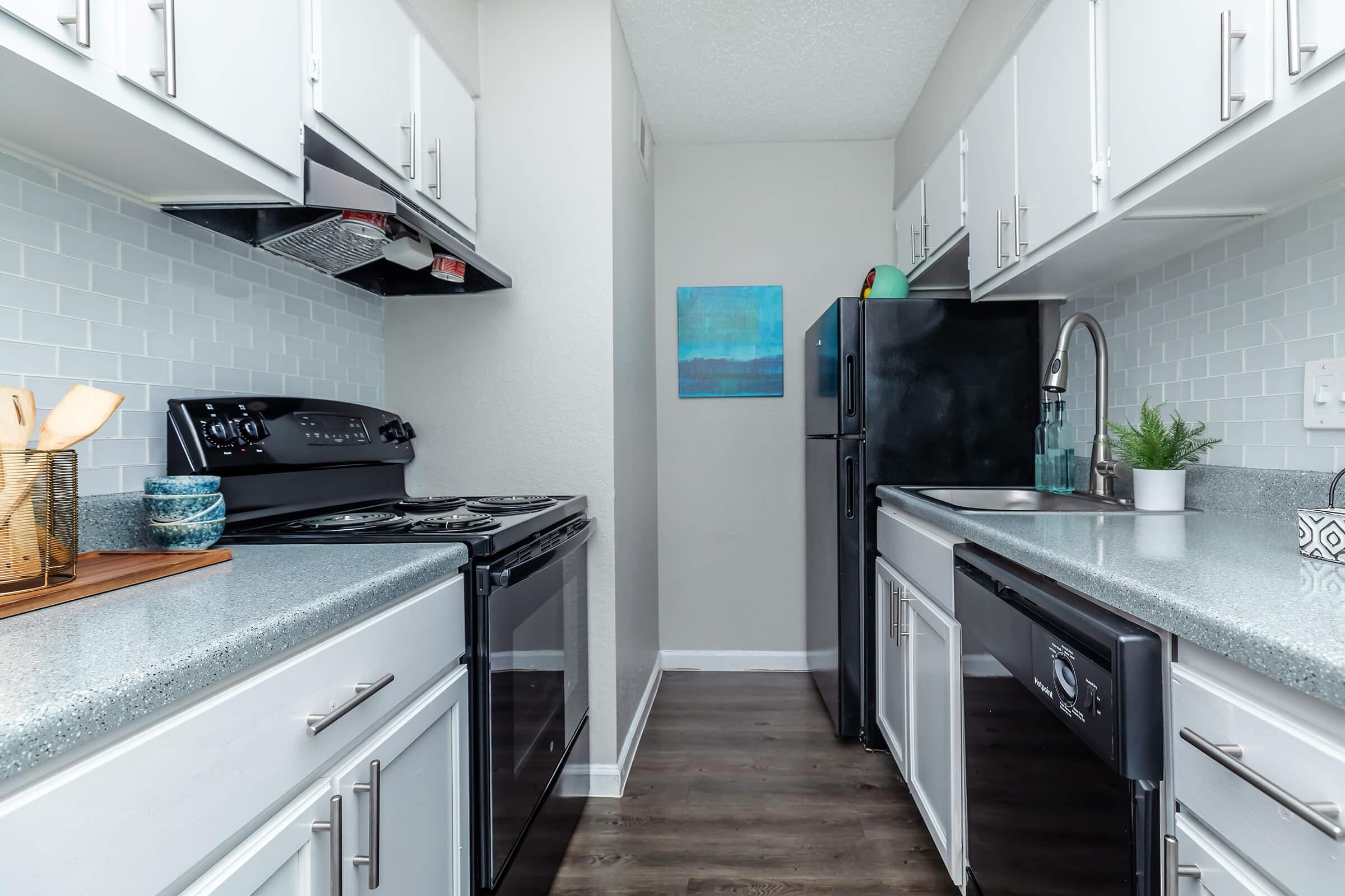 a kitchen with a stove a sink and a microwave