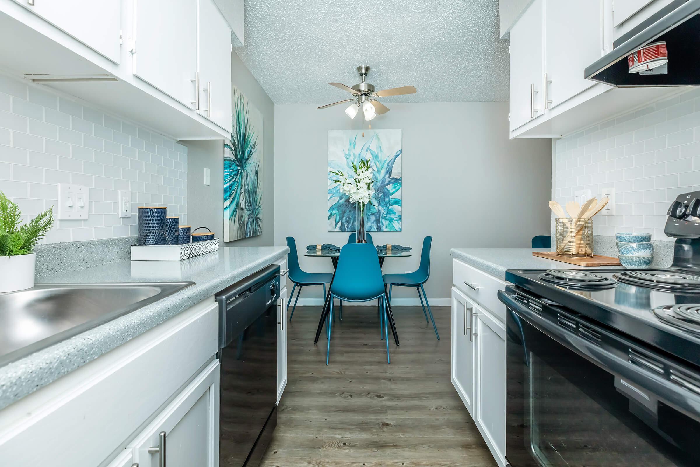 a kitchen with a stove top oven sitting inside of a room