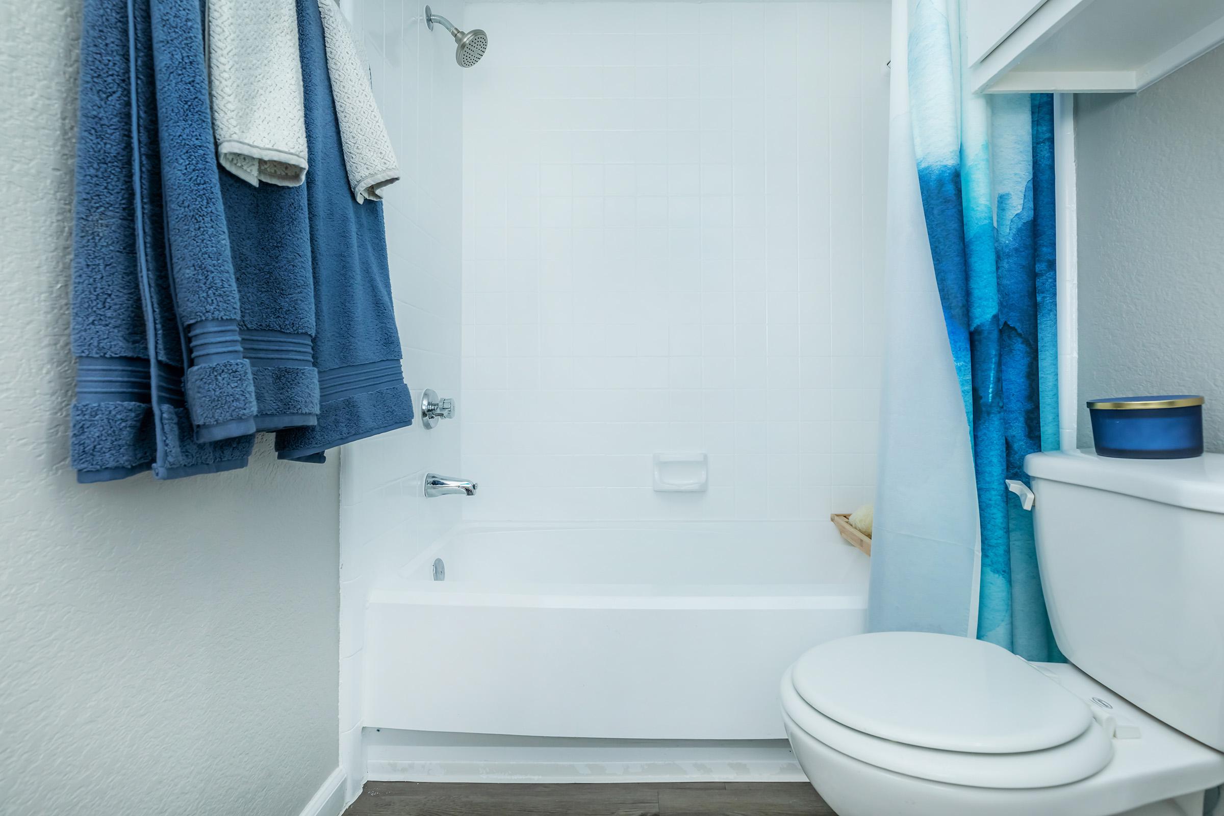 a shower with a towel hanging on the wall