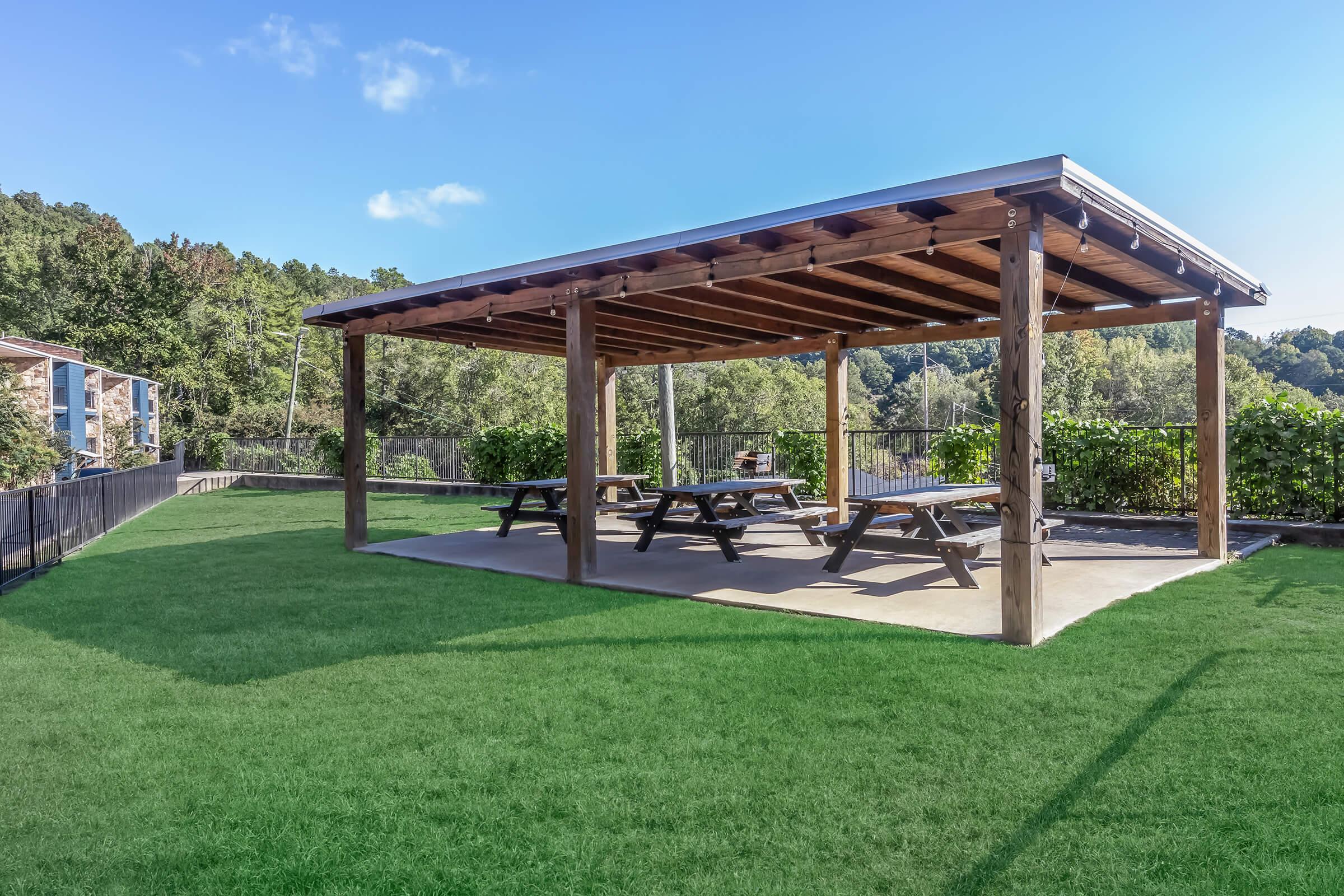 a group of lawn chairs sitting on top of a grass covered field