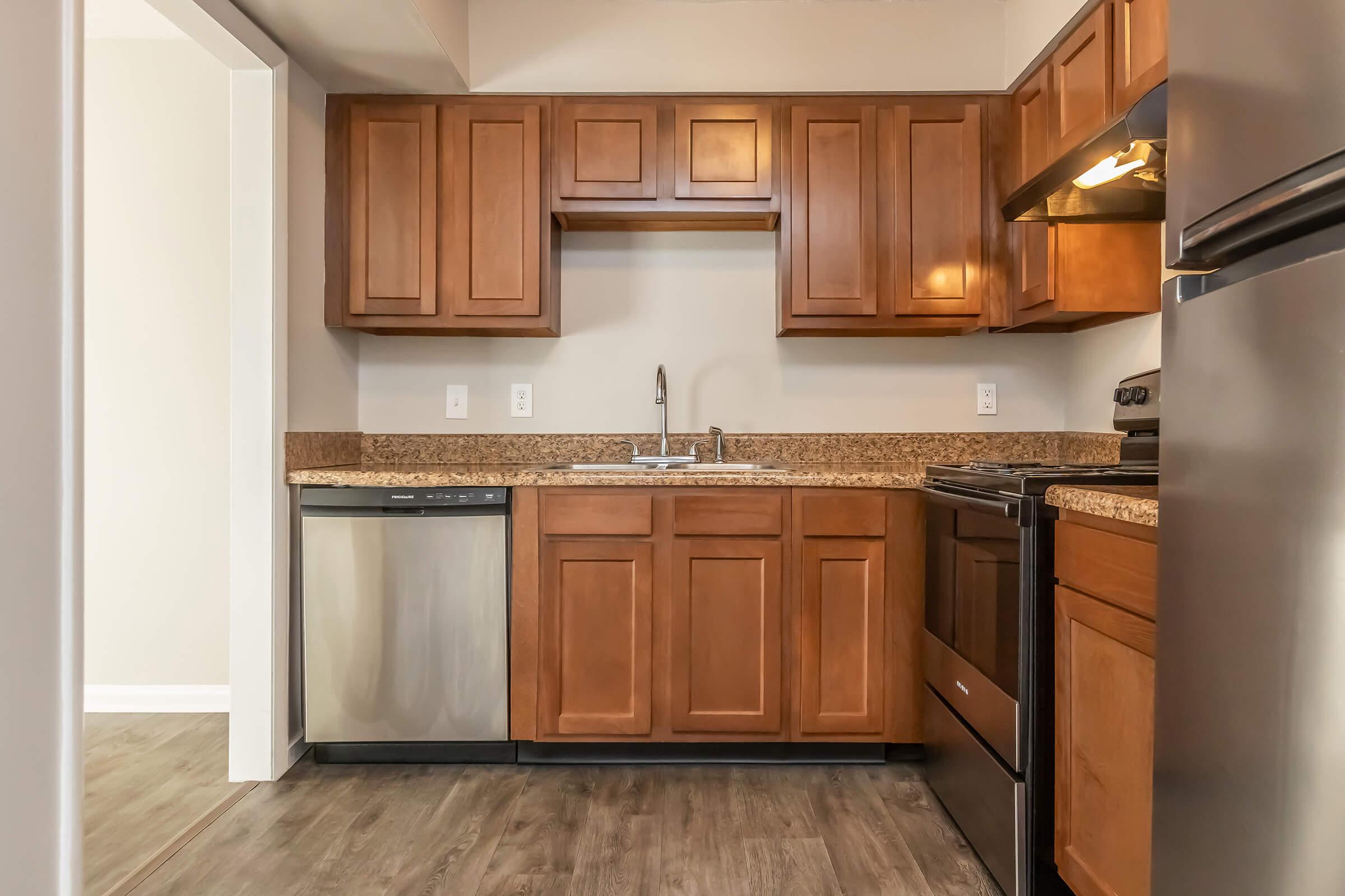 a kitchen with stainless steel appliances and wooden cabinets