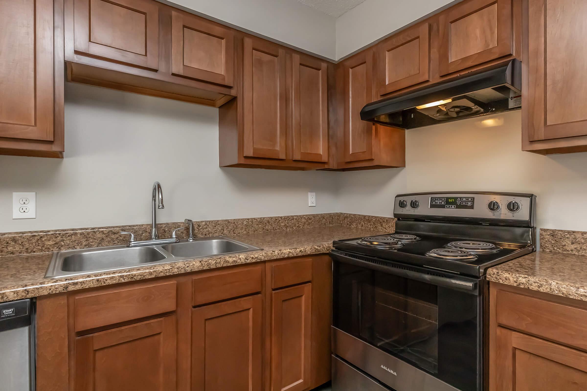 a kitchen with stainless steel appliances and wooden cabinets