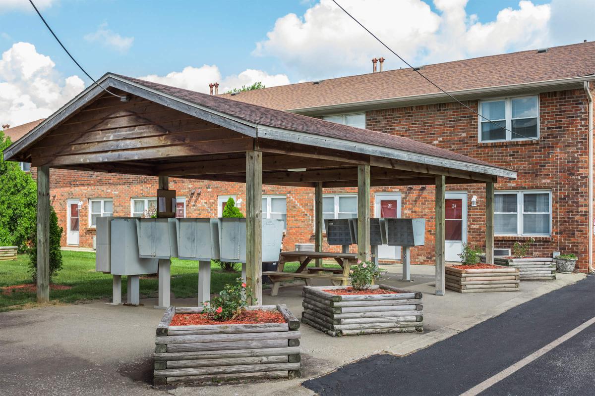 a bench in front of a brick building