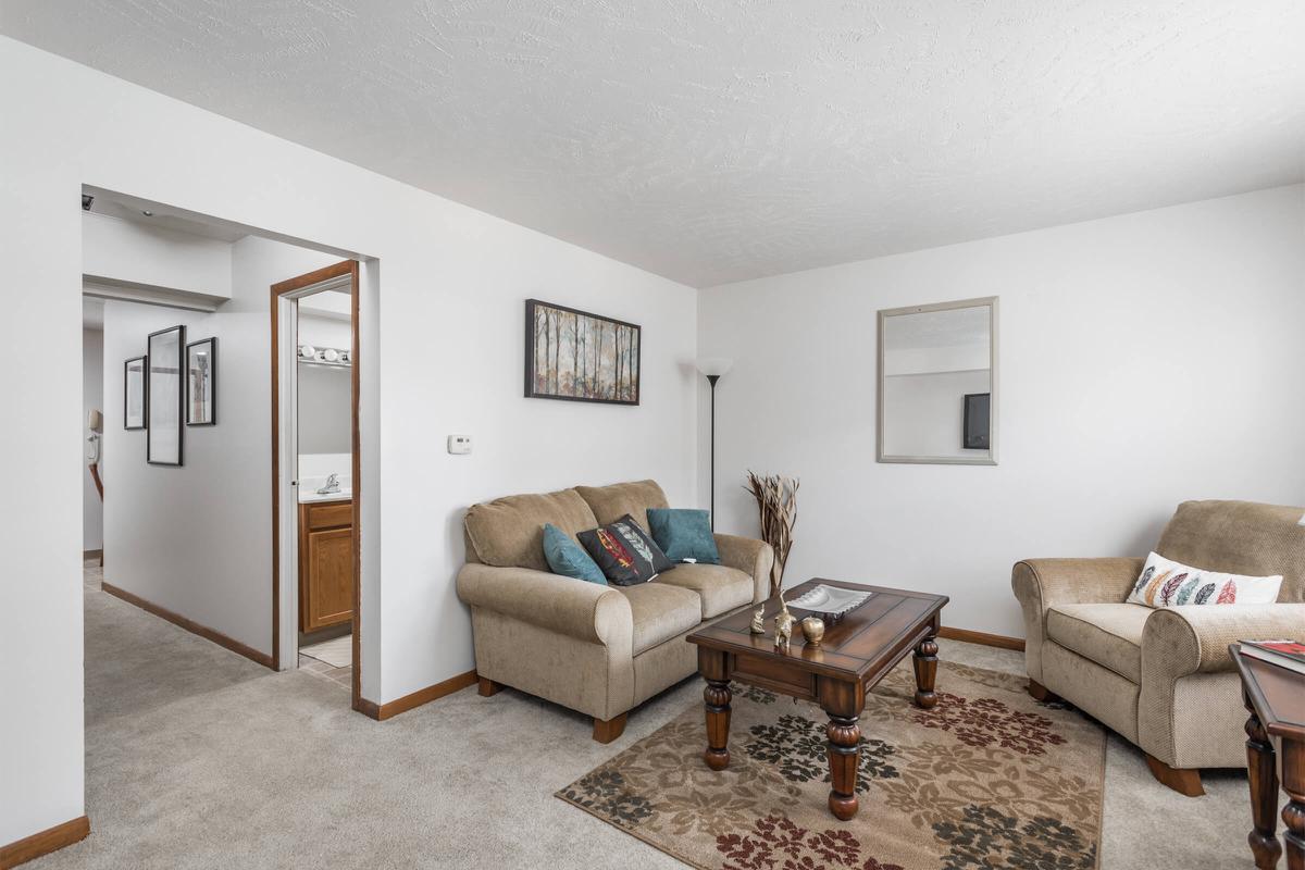 a living room filled with furniture and a flat screen tv