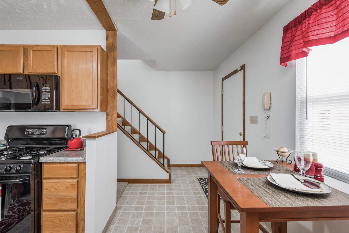 a stove top oven sitting inside of a kitchen