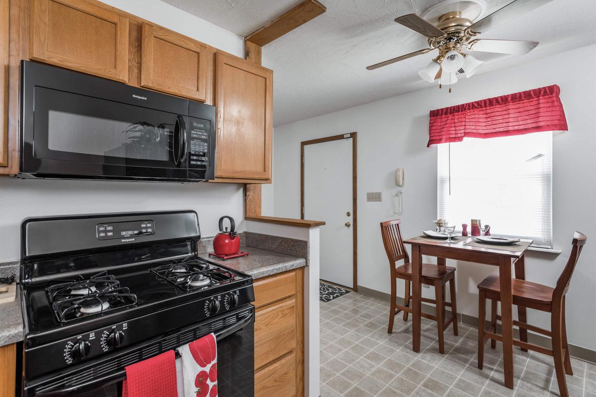 a kitchen with stainless steel appliances and wooden cabinets