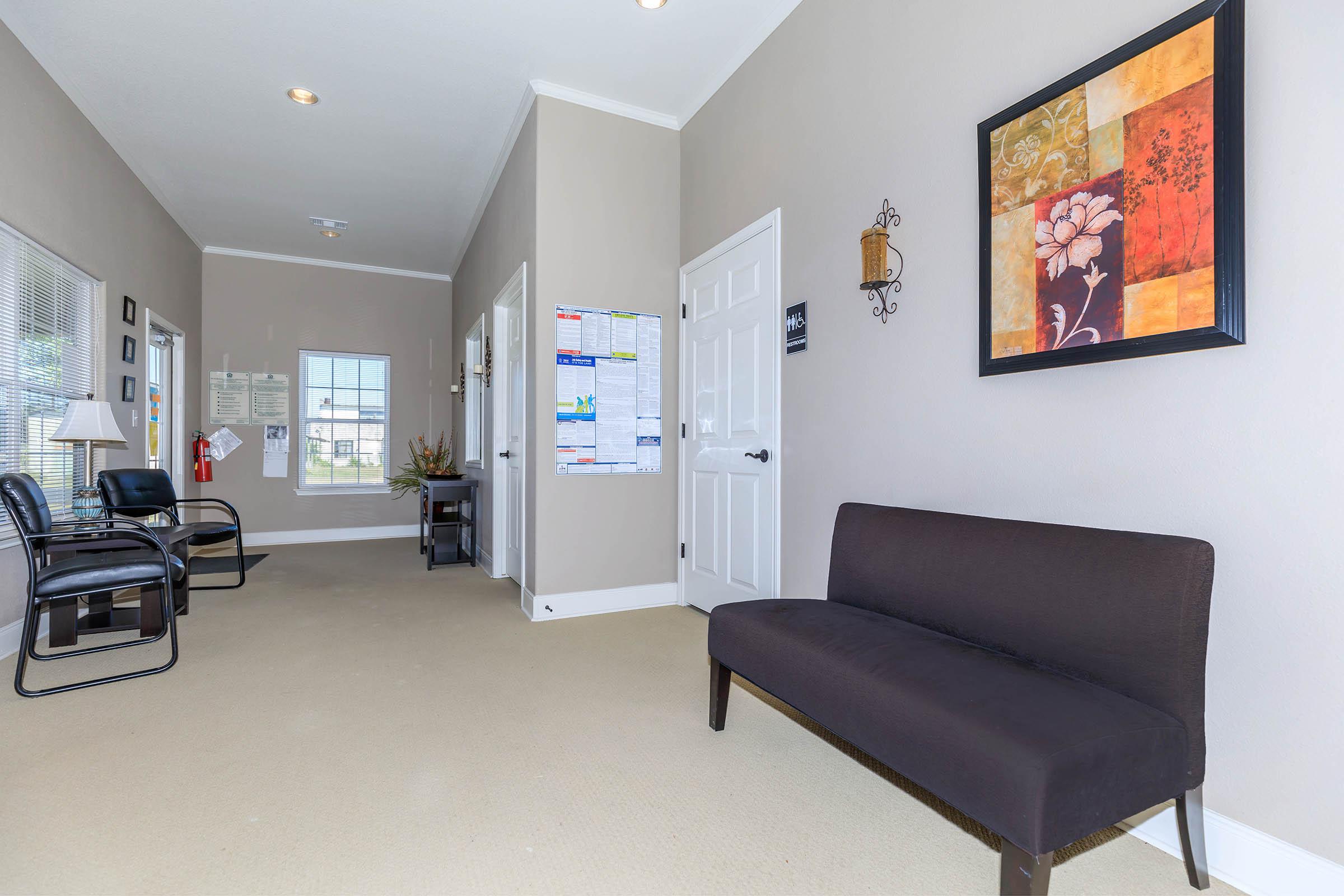 a living room filled with furniture and a tv