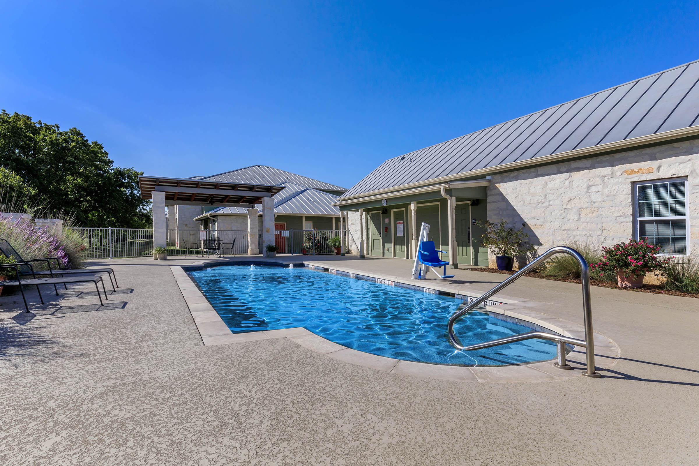 a house with a pool outside of a building