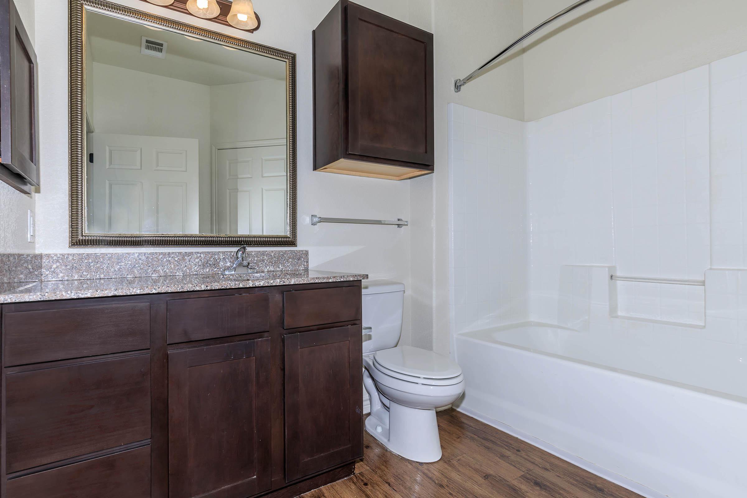 a large white tub sitting next to a sink