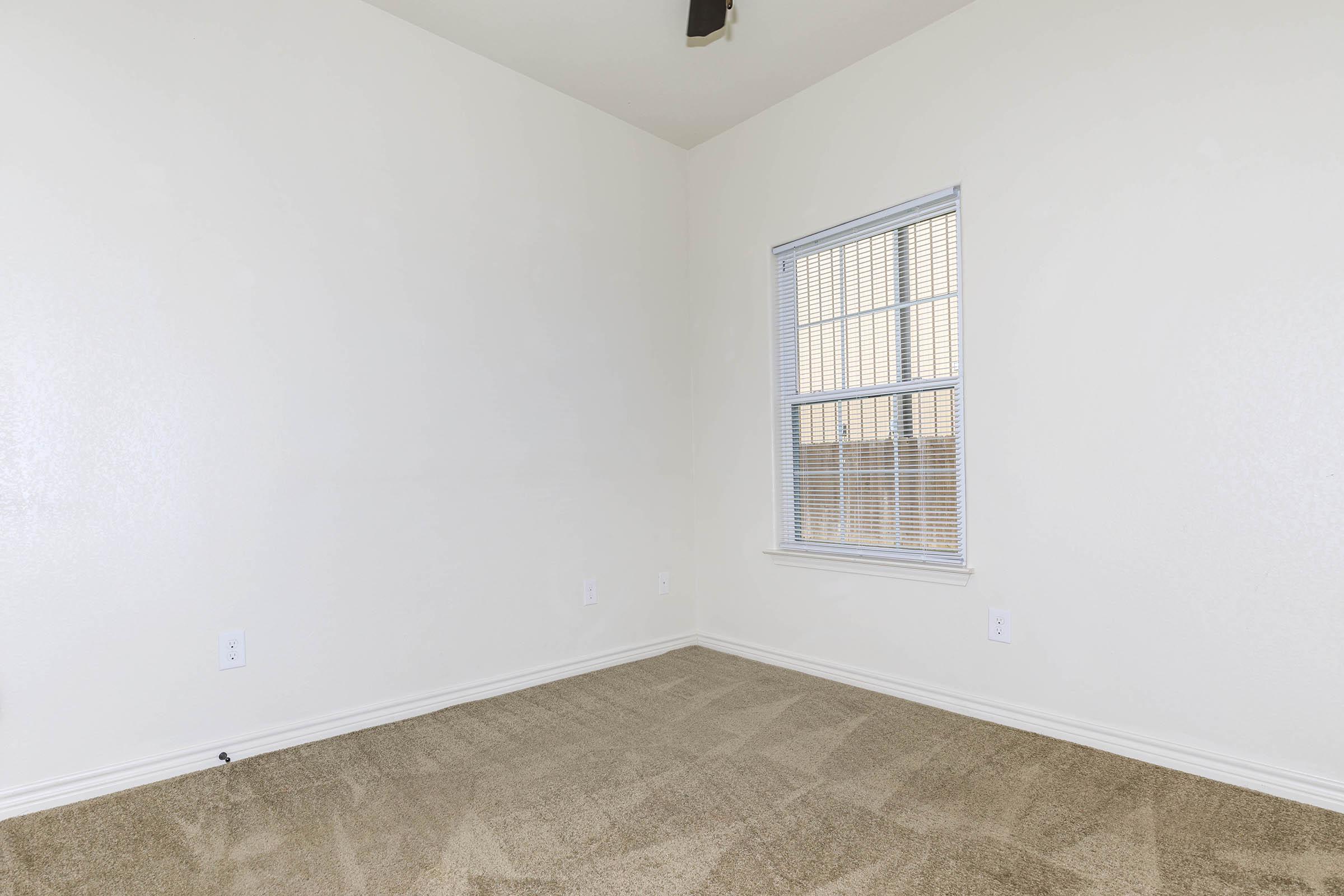 a bedroom with a large window