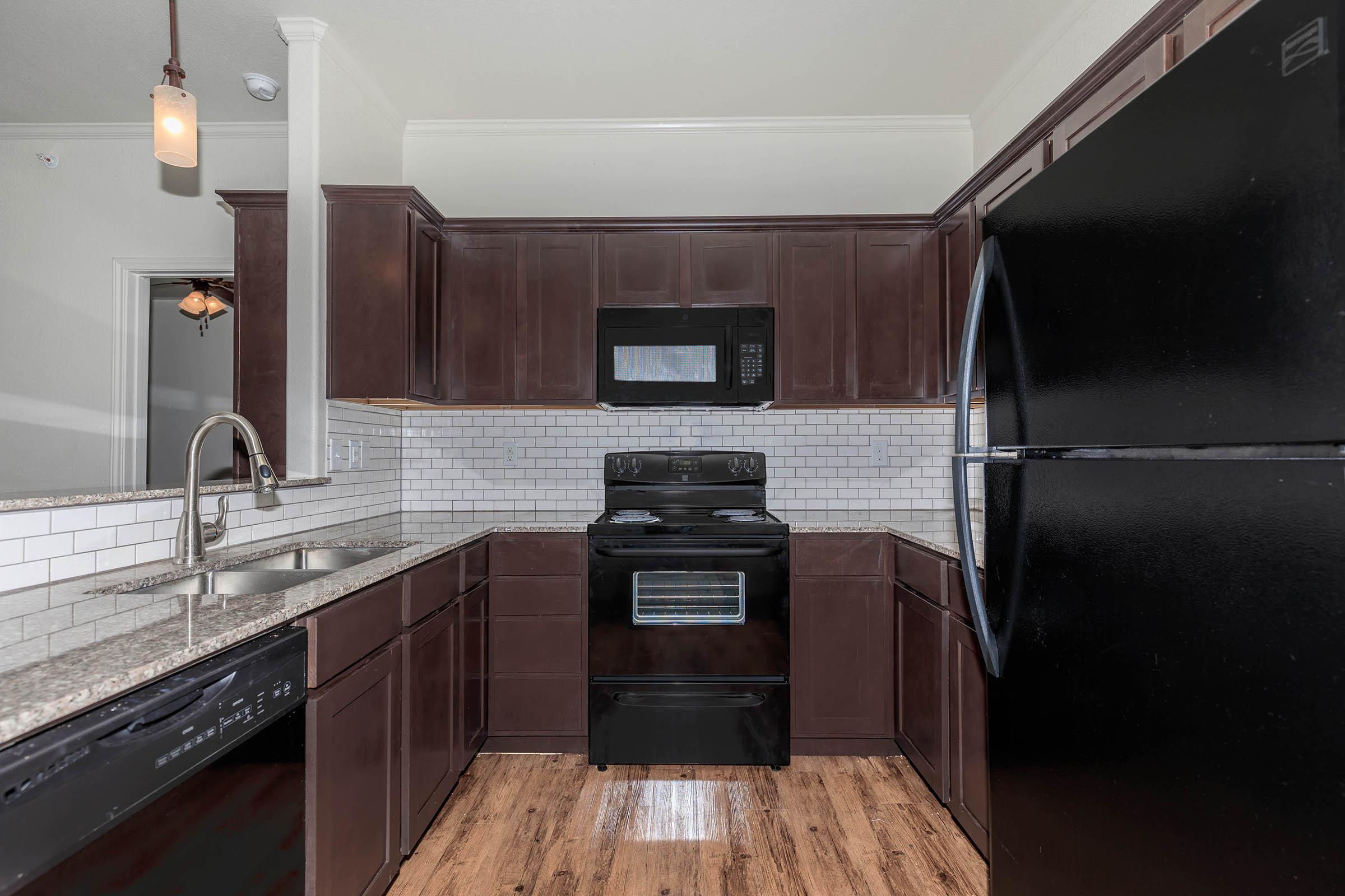 a kitchen with stainless steel appliances and wooden cabinets