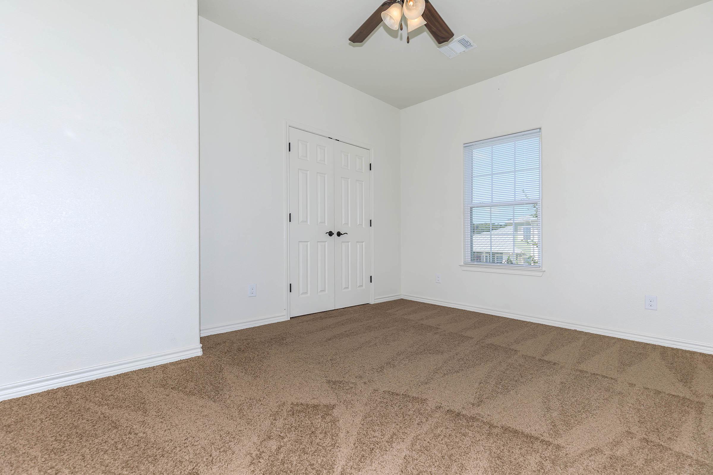 a bedroom with a large window