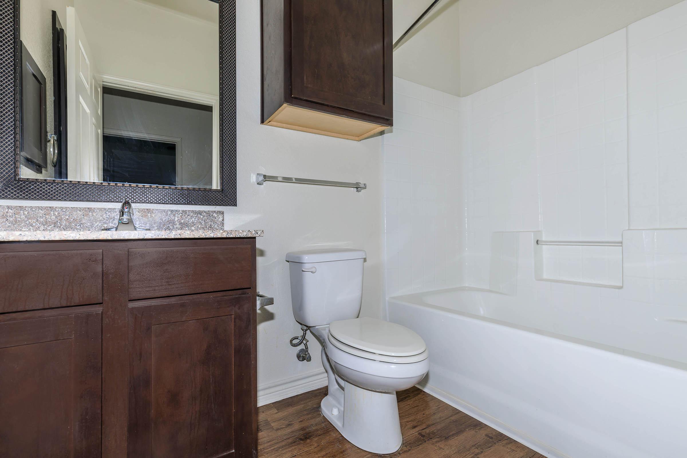 a white tub sitting next to a sink