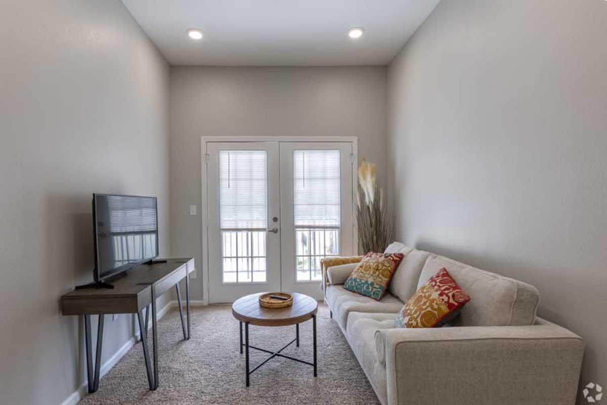 a living room filled with furniture and a large window