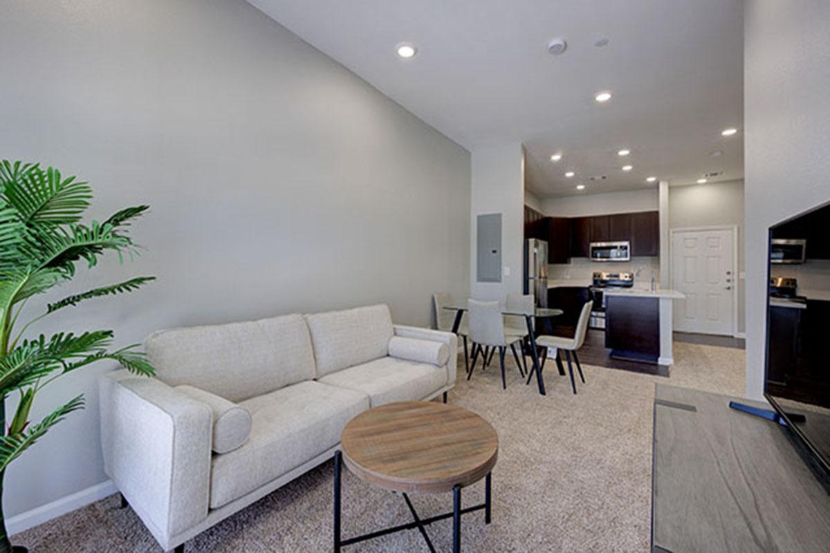 a living room filled with furniture and a large window