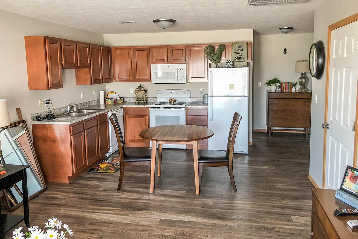 a living room filled with furniture and a wood floor